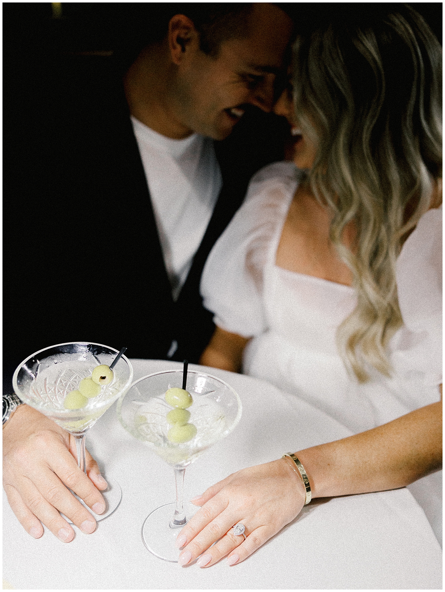 candid photo of couple laughing at restaurant during Upscale Romantic Engagement Session at Luciano’s Restaurant