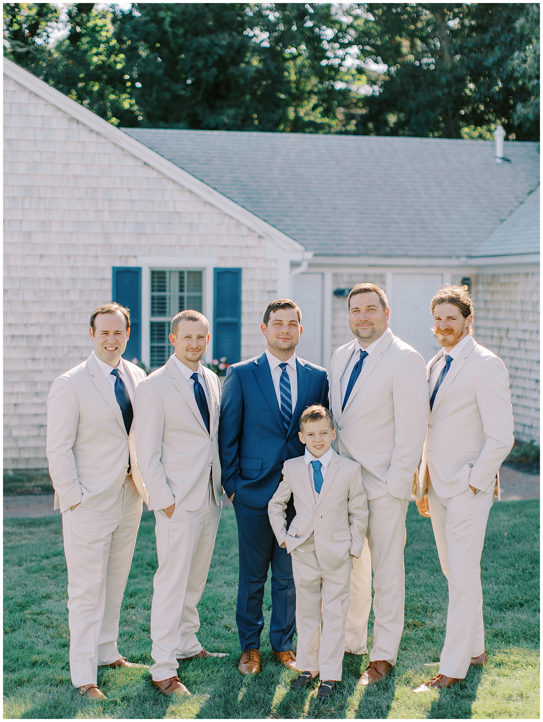 groom and groomsmen in cream suits
