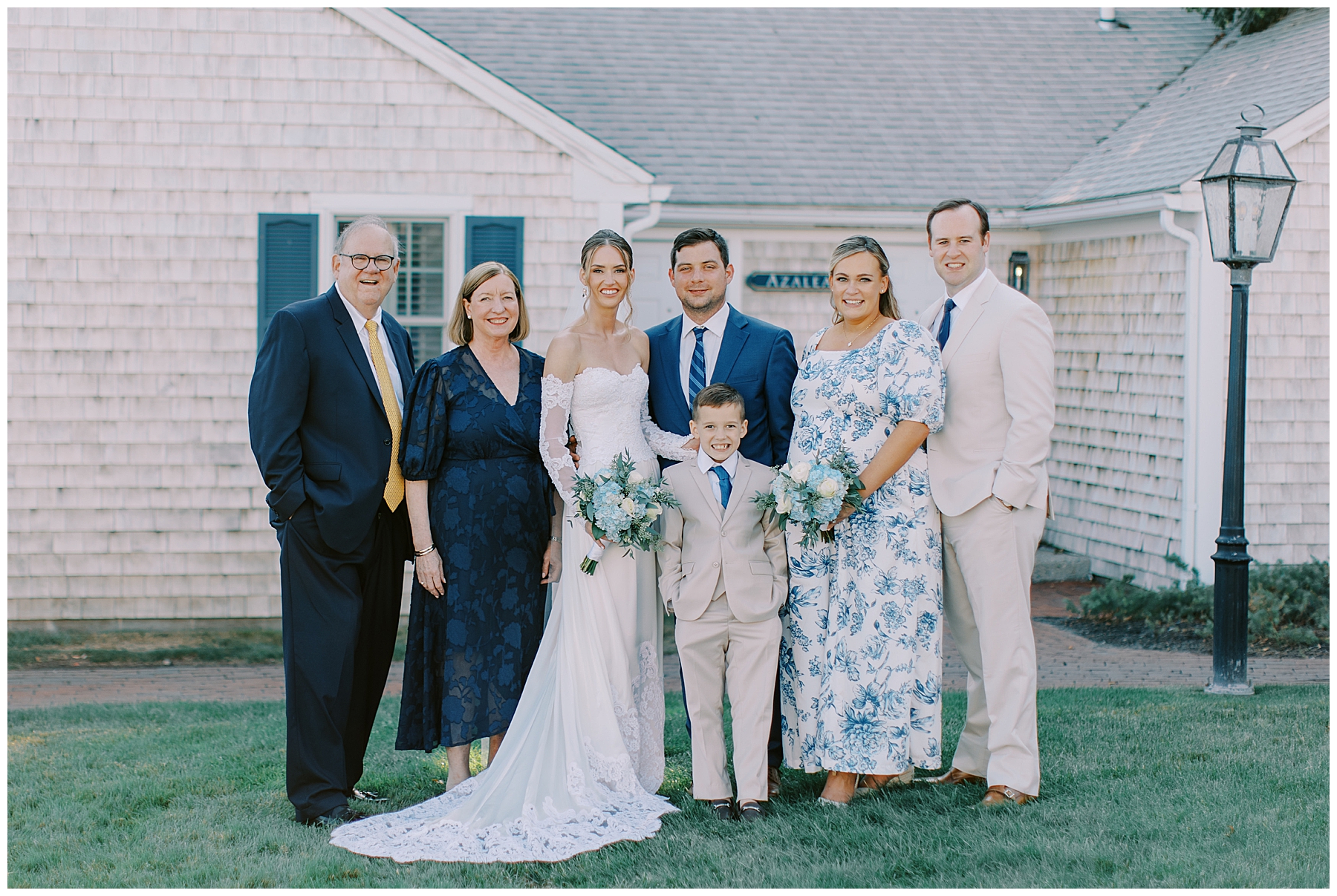 bride and groom take photos with family members