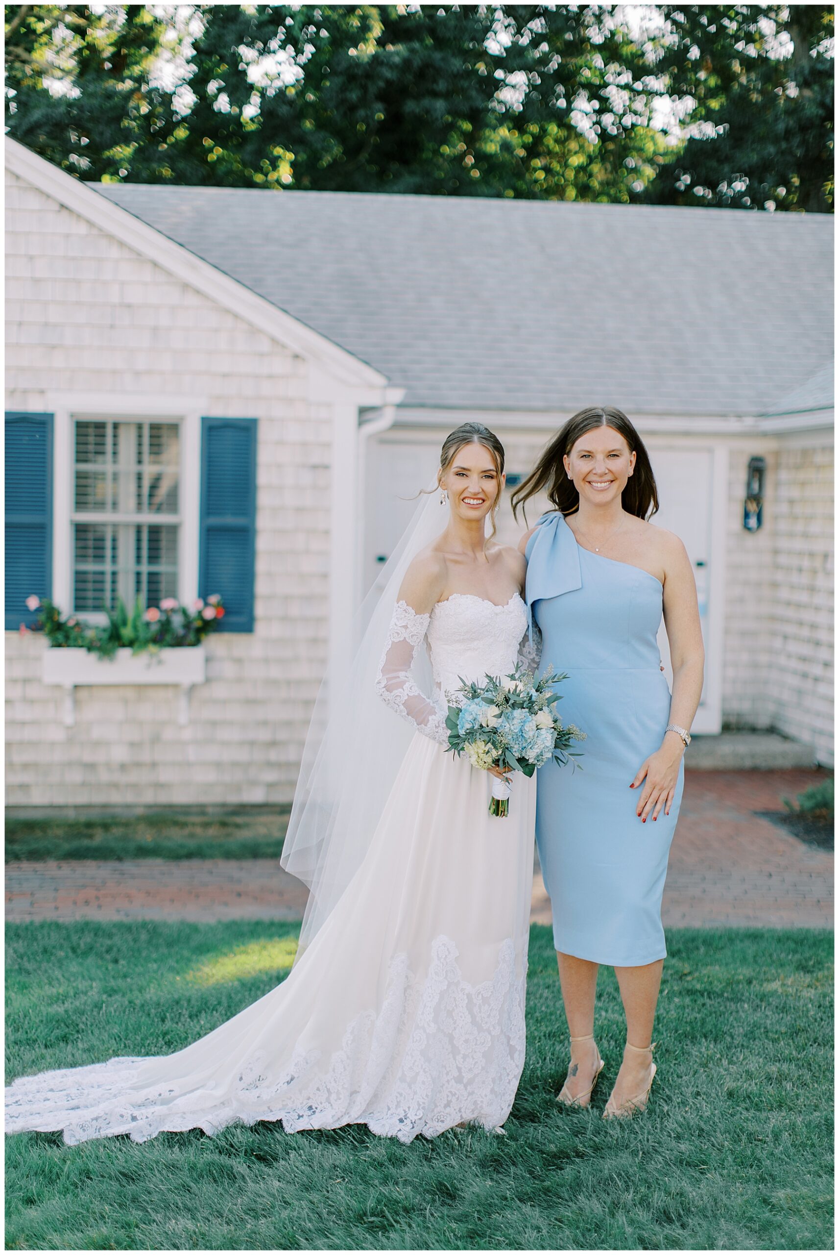 bride with woman in dusty blue dress