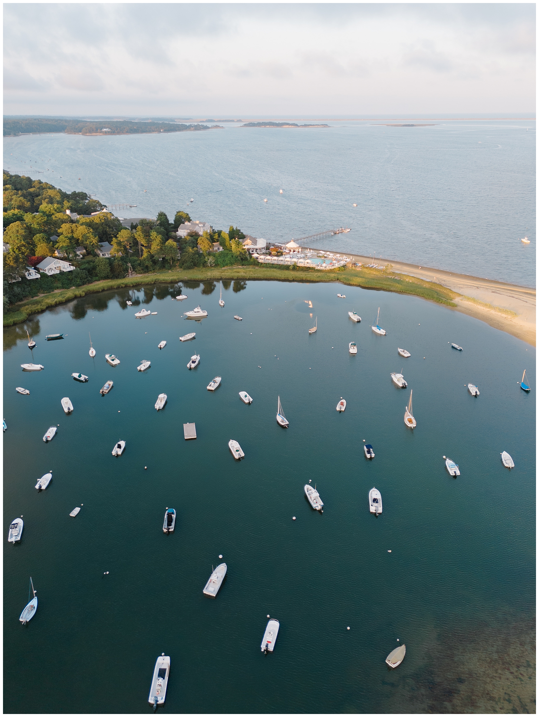aerial photo of boats in the water in the bay at Cape Cod