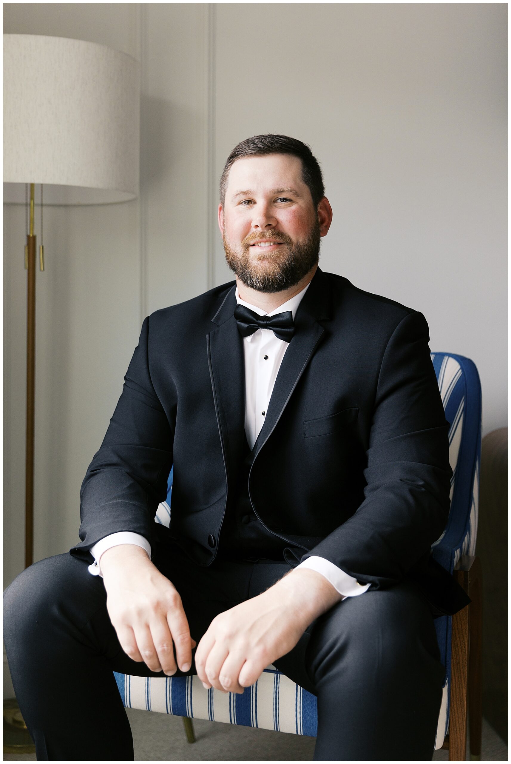 groom sits in chair