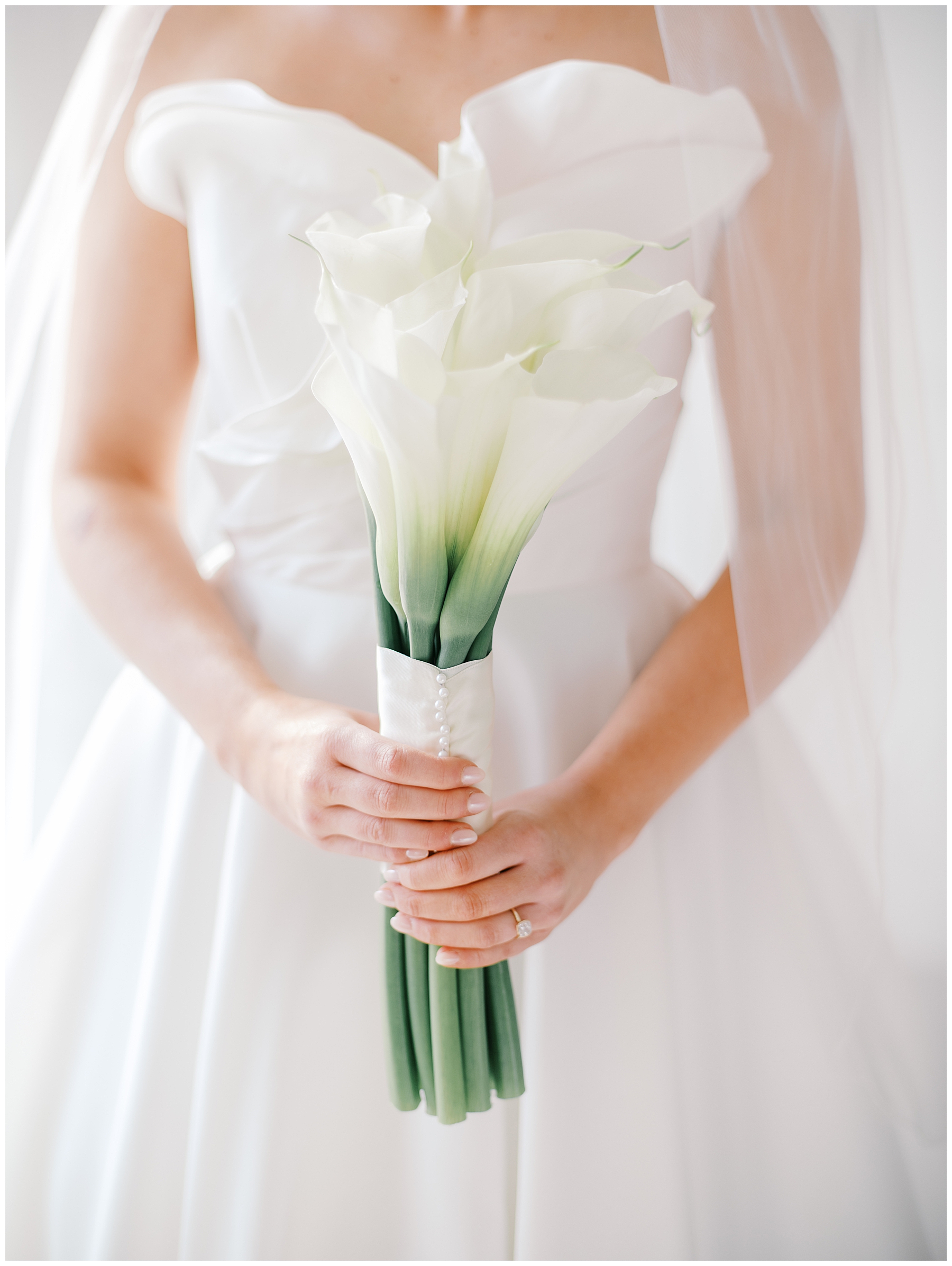 bride in wedding dress holding simple white flower bouquet