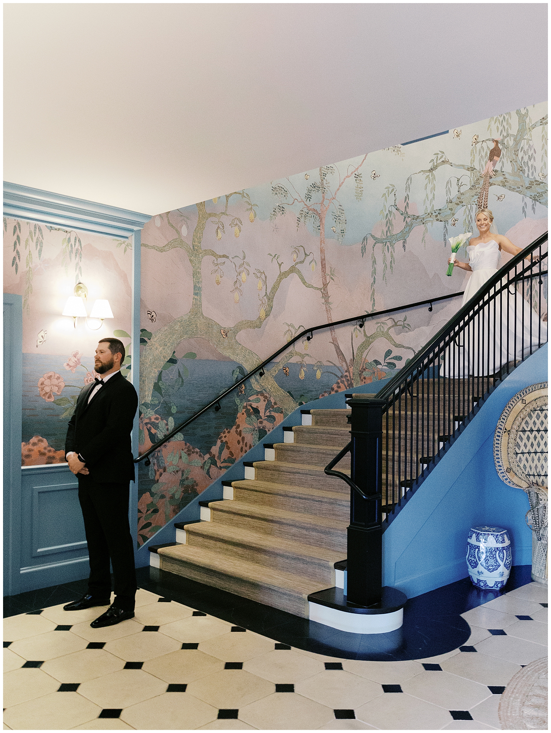 bride walking down staircase to meet groom for first look