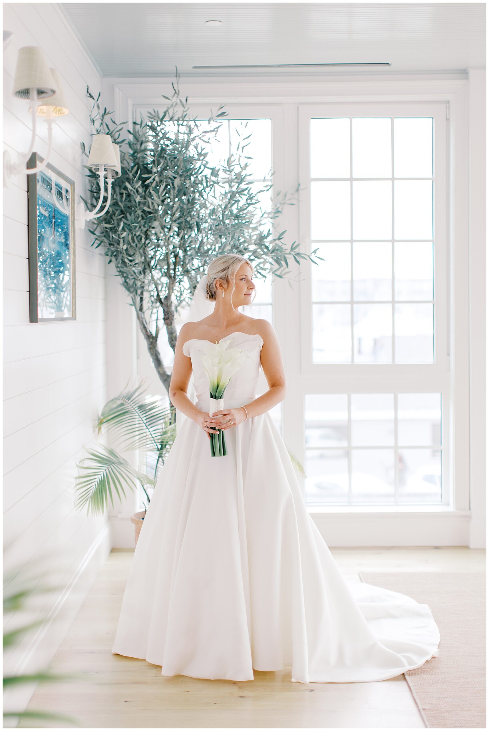 bride in strapless wedding gown holding clean and simple bouquet