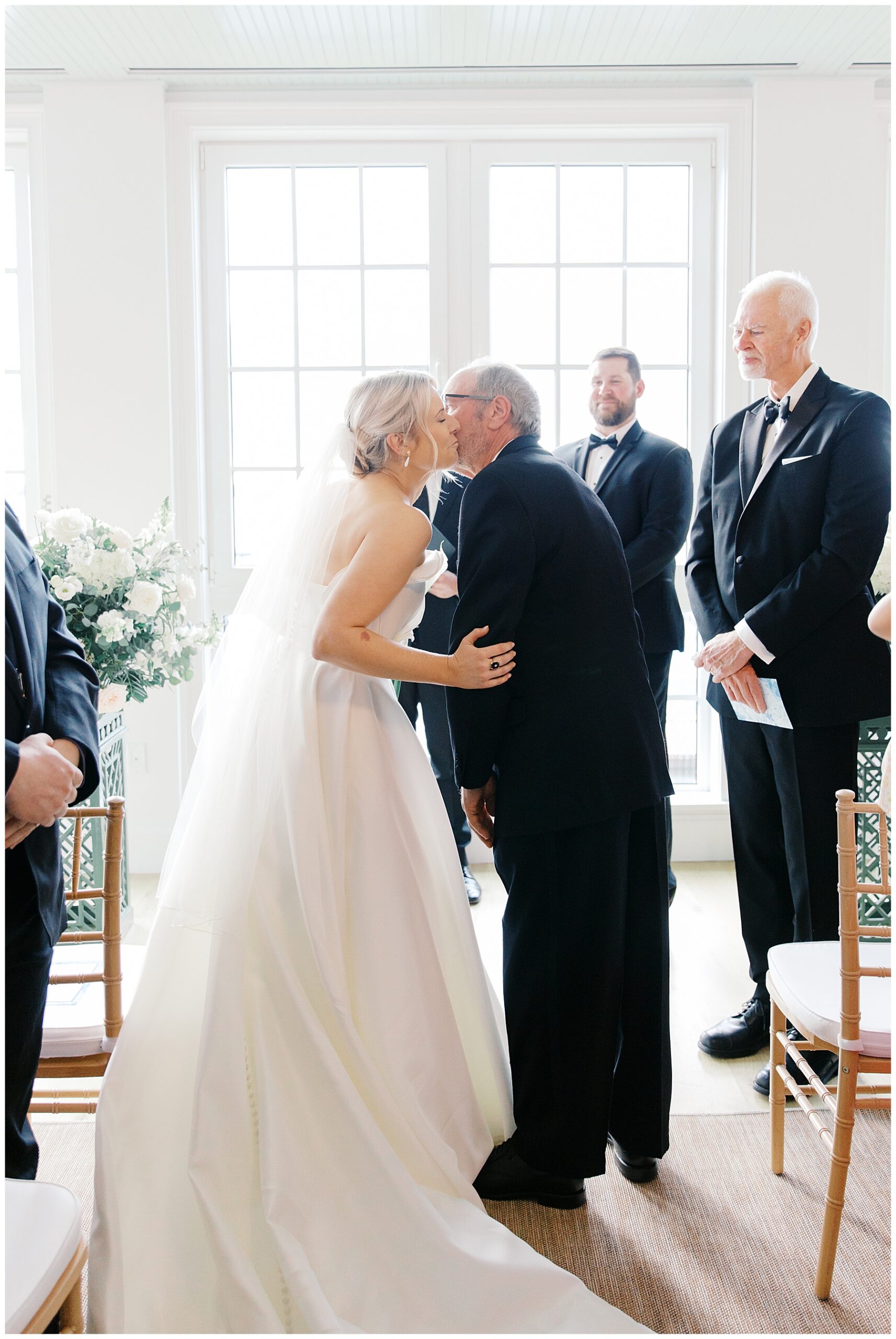 father gives daughter away at wedding ceremony at Gardiner House Sun Room