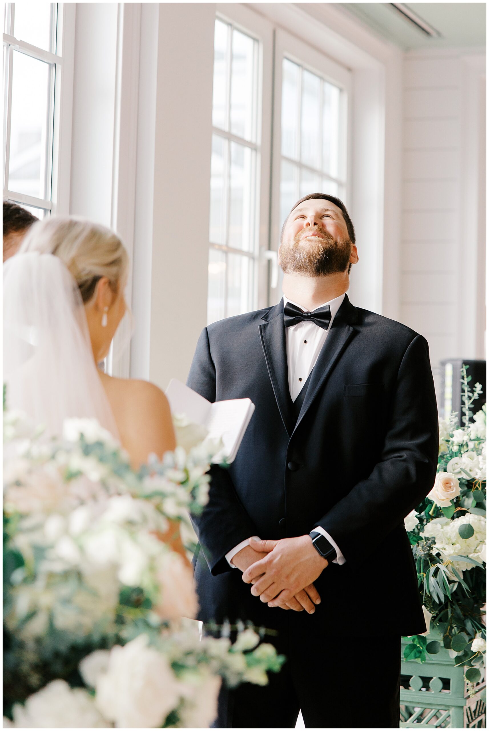 candid photo of groom's reaction during vow exchange
