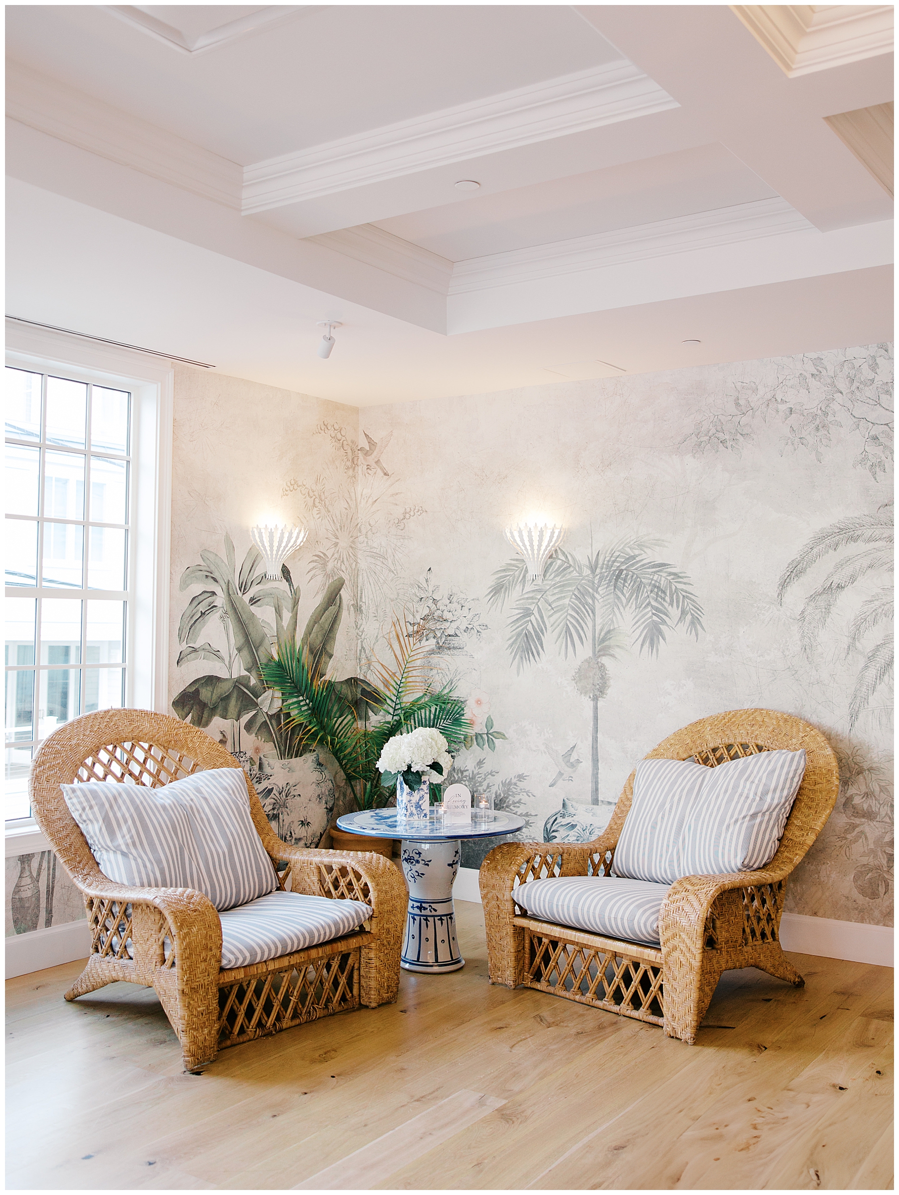 sitting area at wedding venue with soft green and pink wallpaper