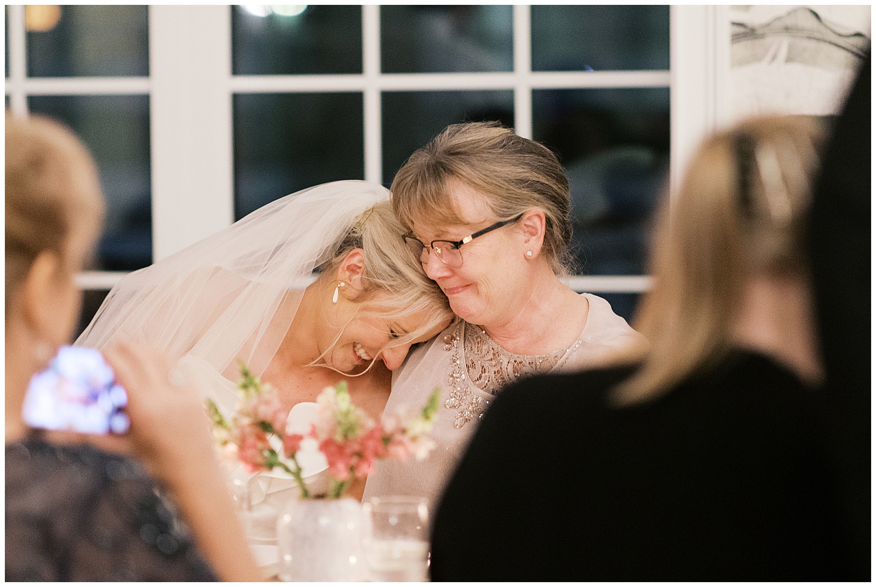 bride rests head on mom's shoulder