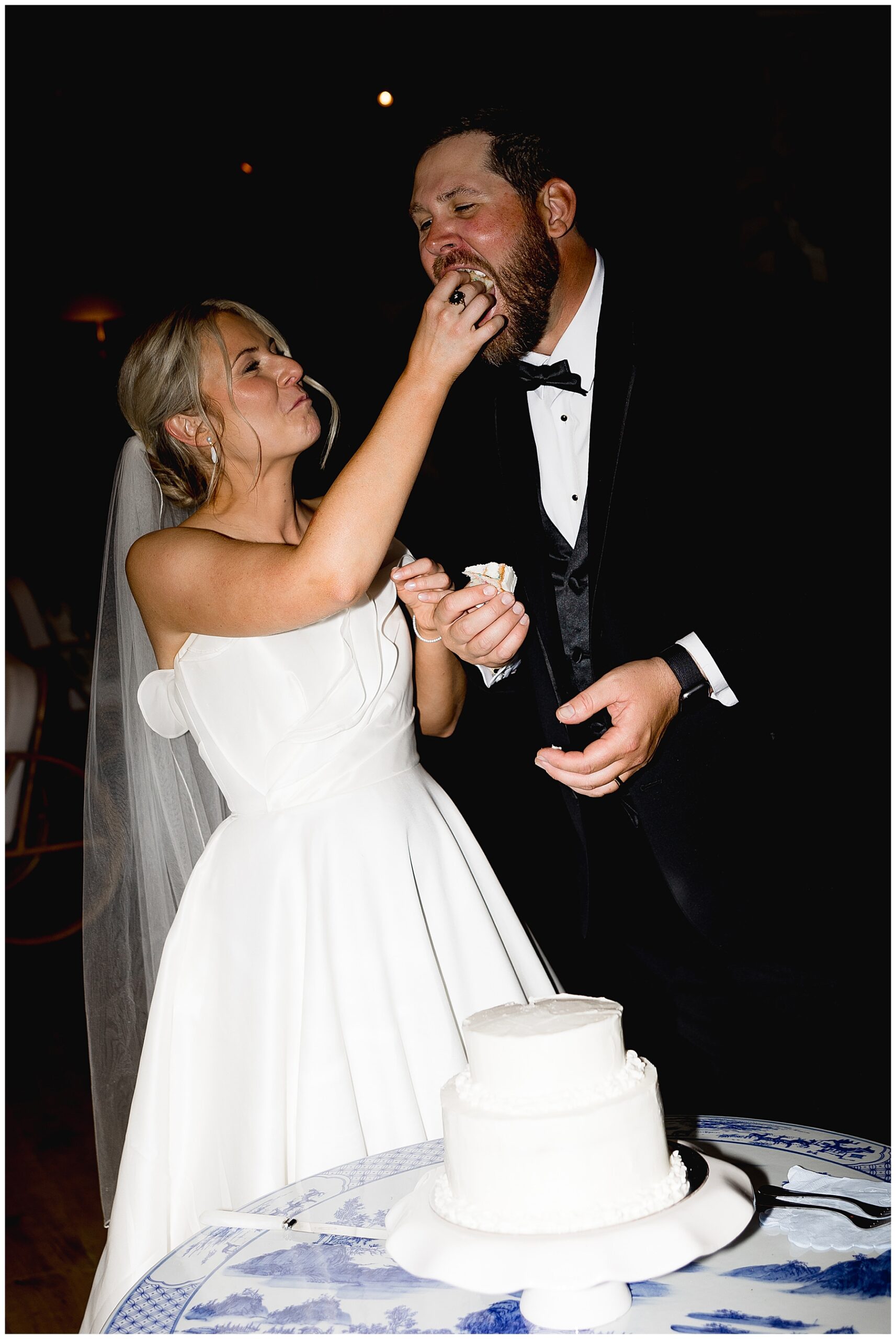 bride feeds groom wedding cake
