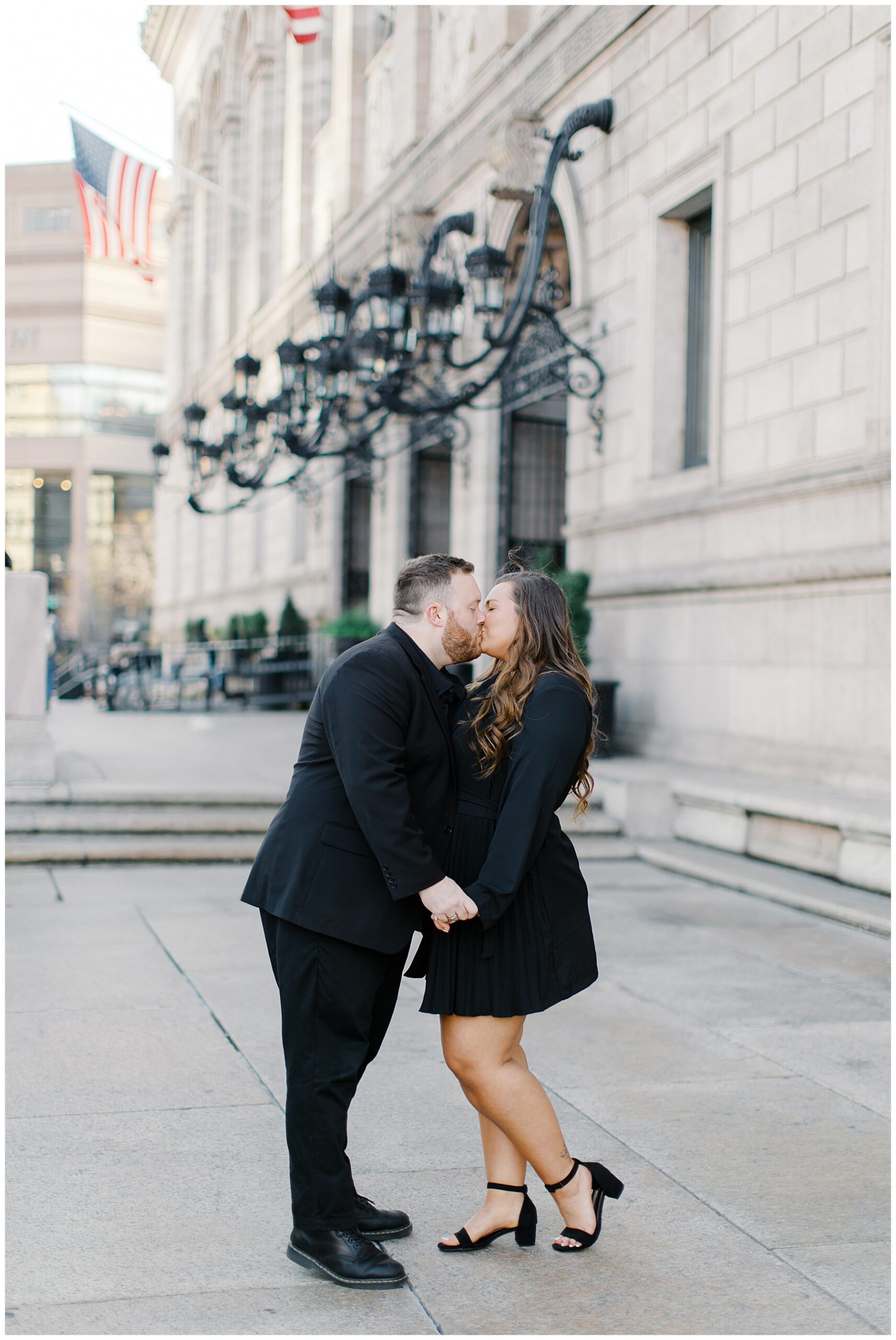 Romantic engagement photos of couple kissing outside of the Boston Public Library 