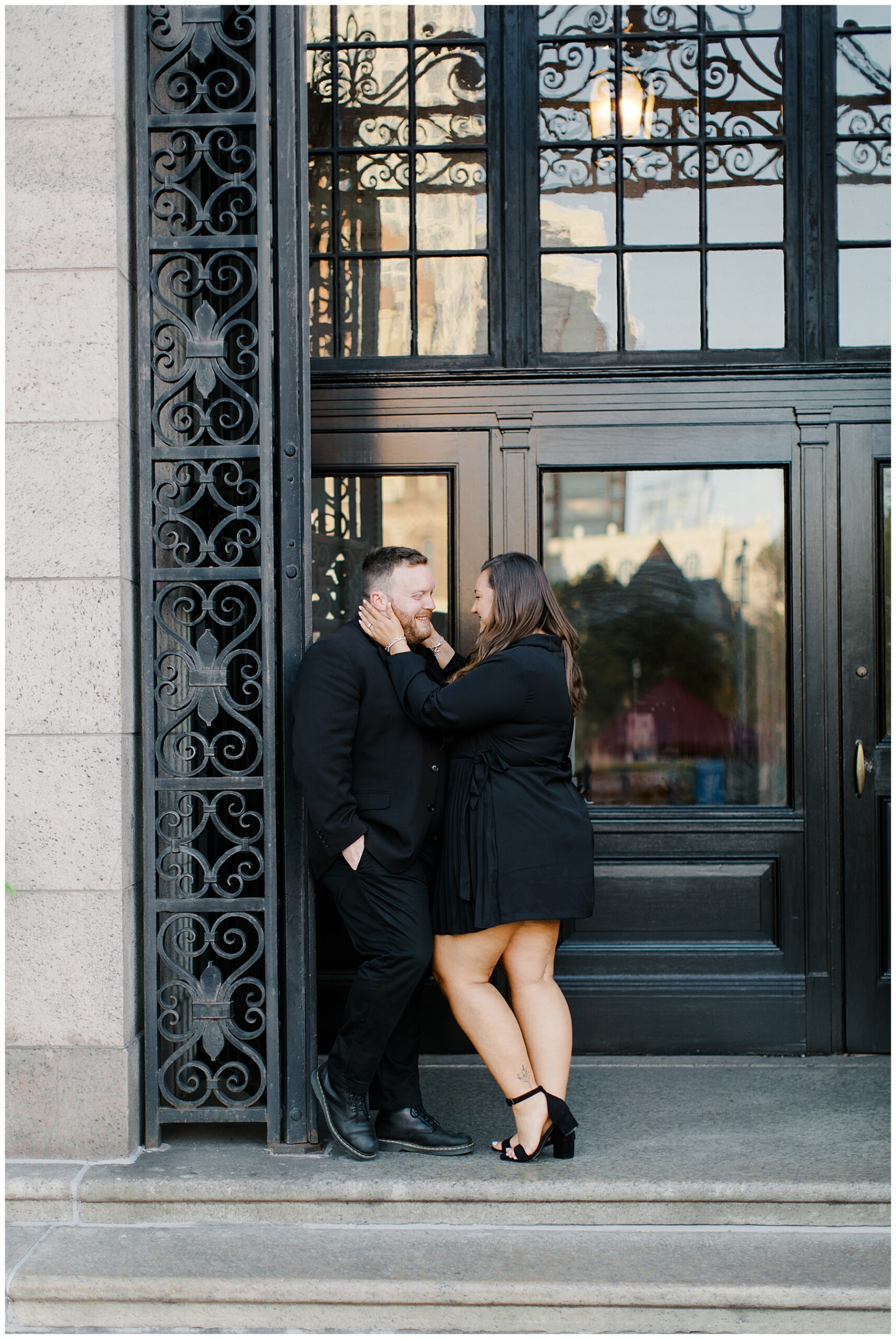 couple lean against entry way of BPL