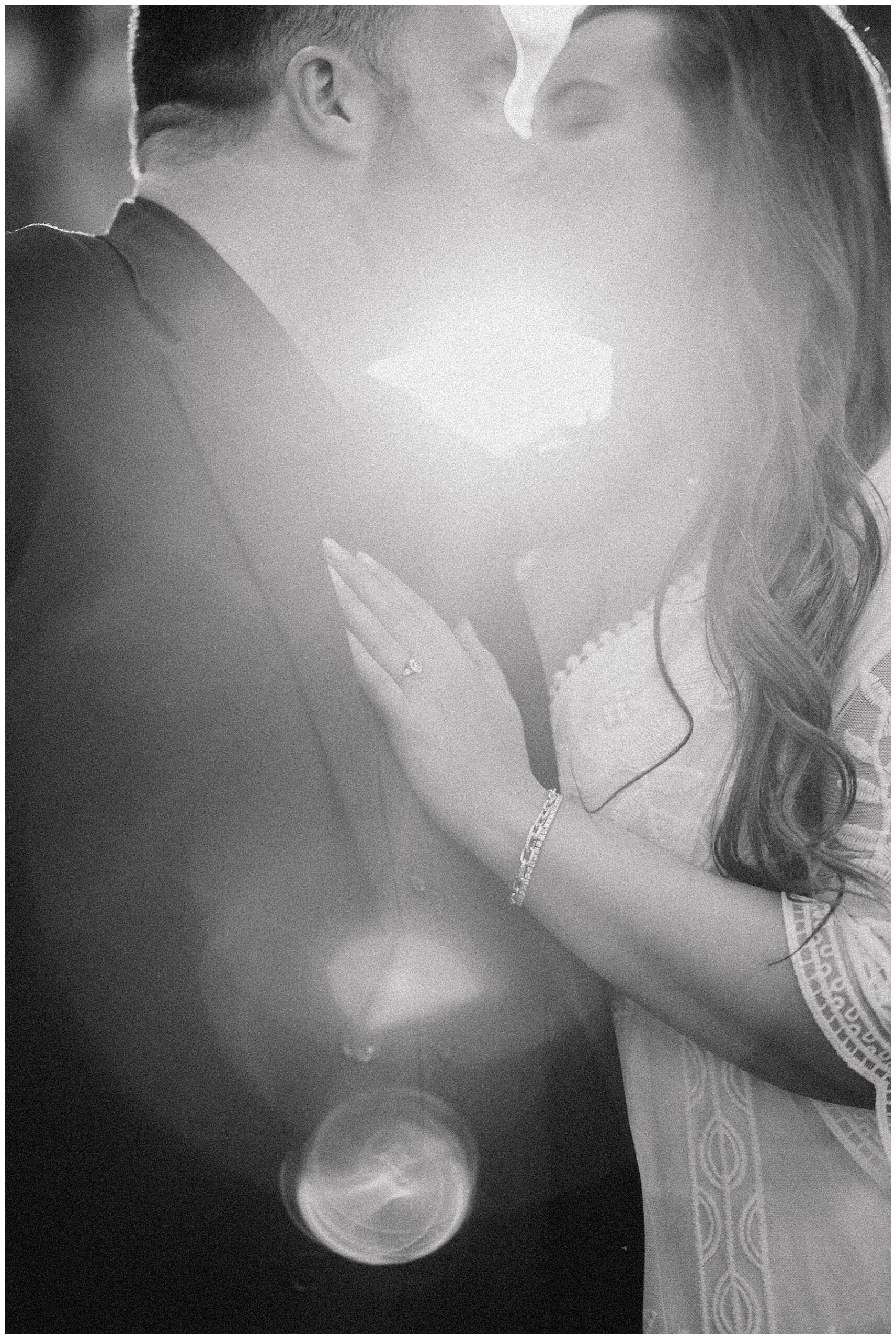 romantic engagement photo in black and white of couple kissing