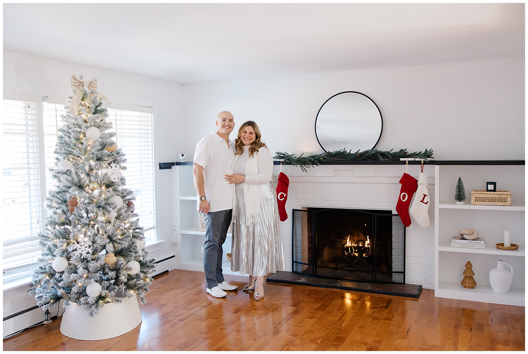 couple portraits in living room of home decorated for Christmas