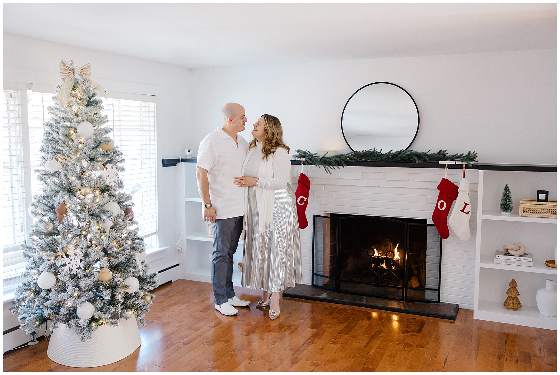 couple portraits in living room of home decorated for Christmas