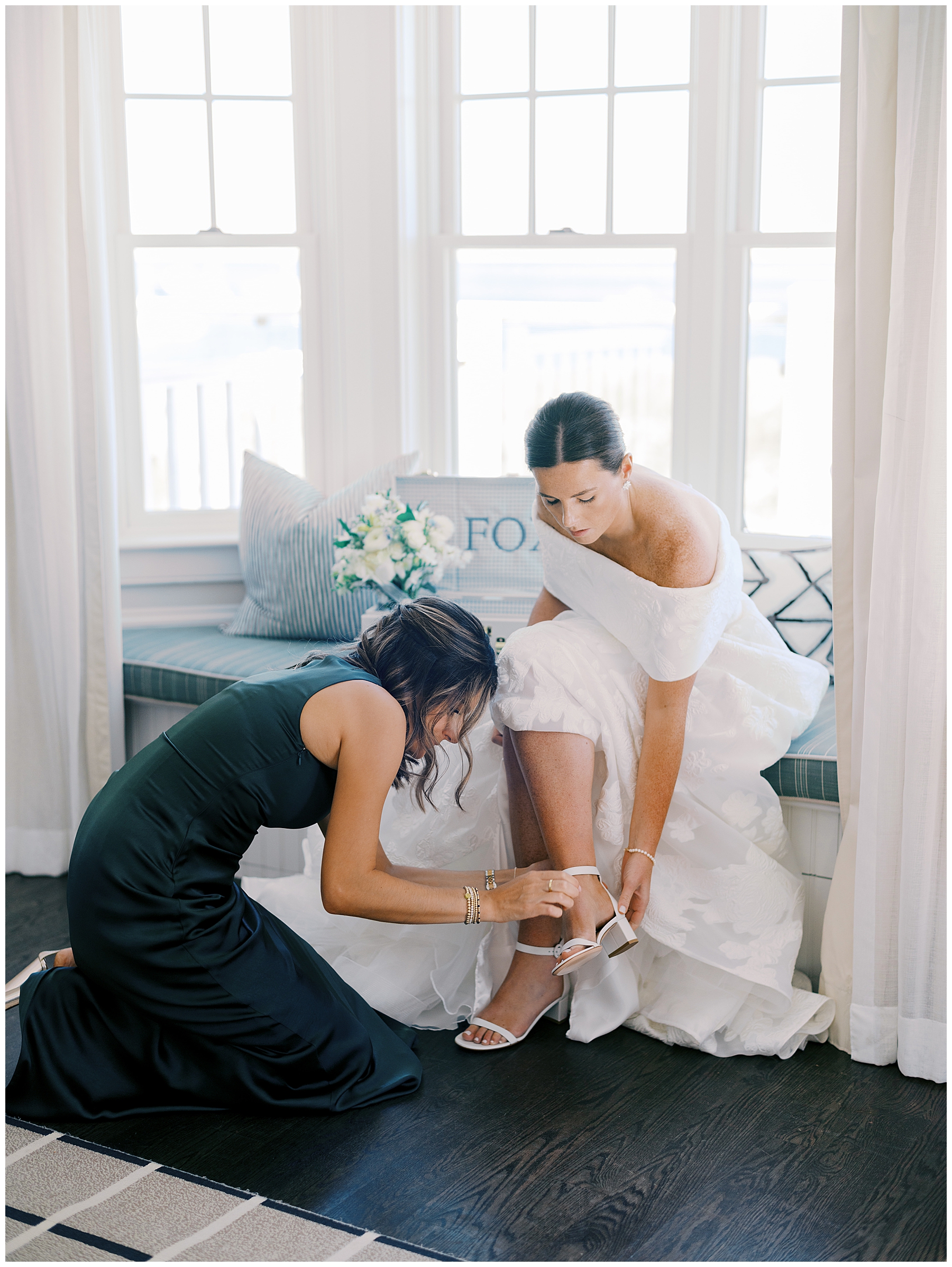 bride putting wedding shoes on 