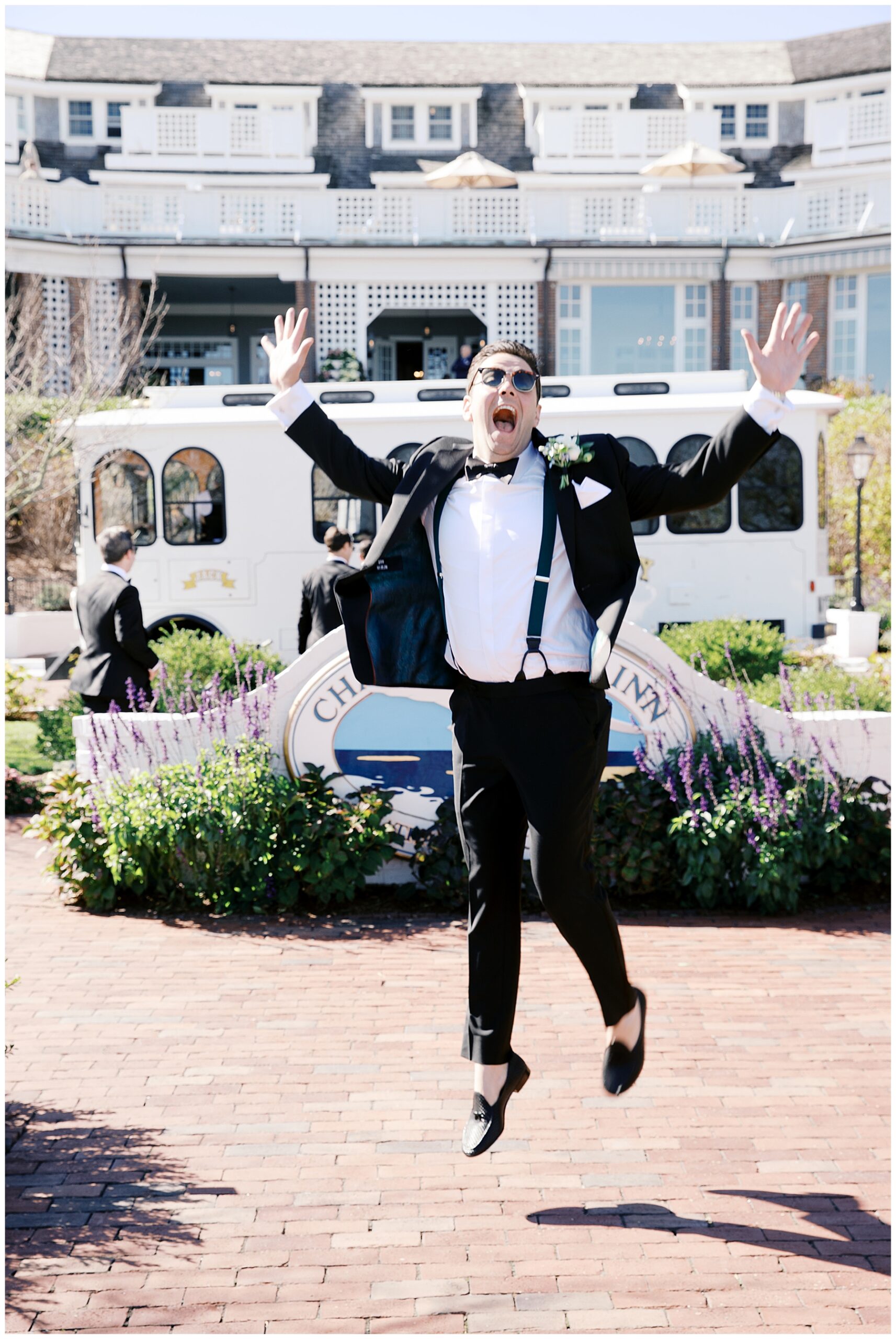 groom jumps up for fun portraits 