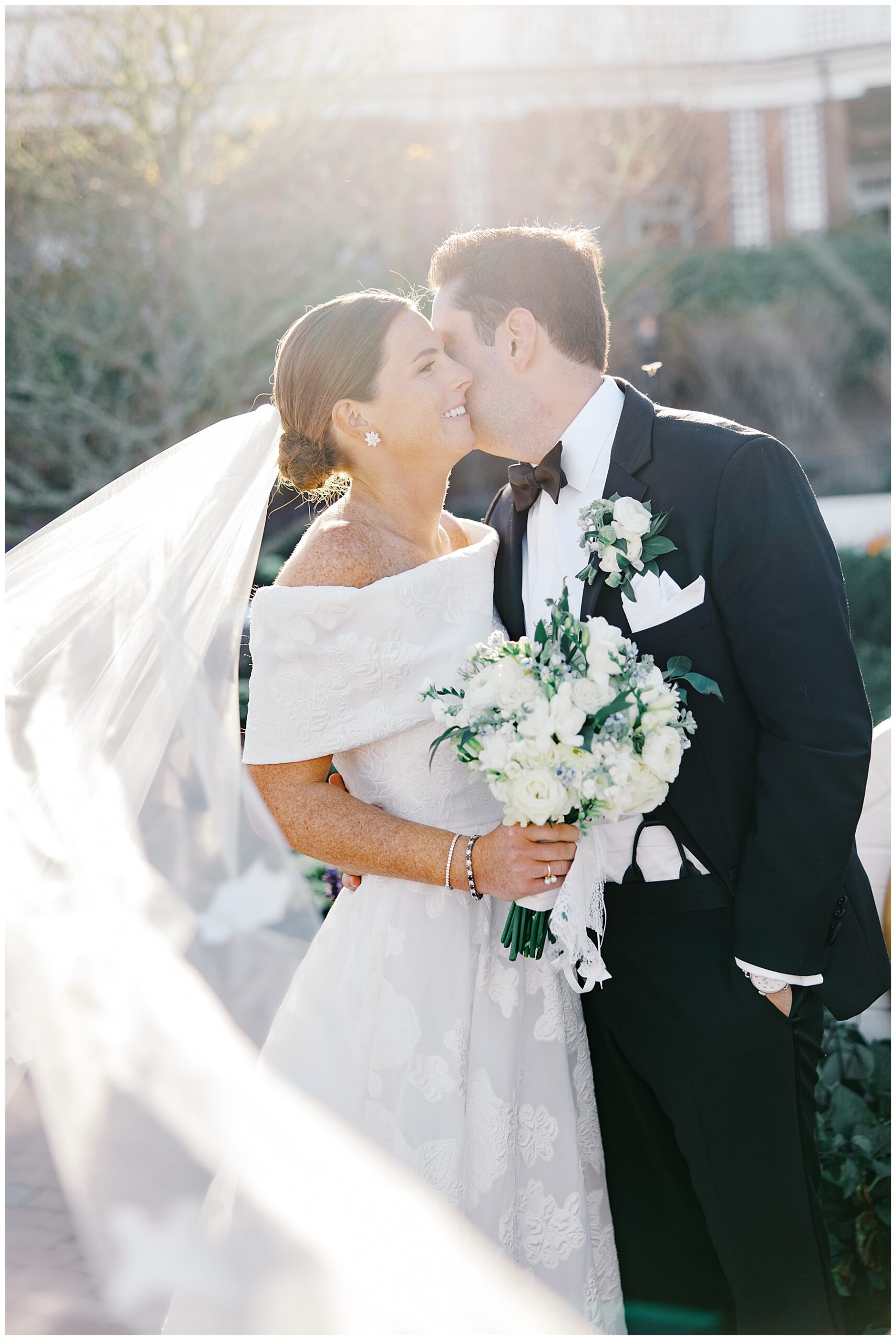 newlyweds kiss in the sunlight 