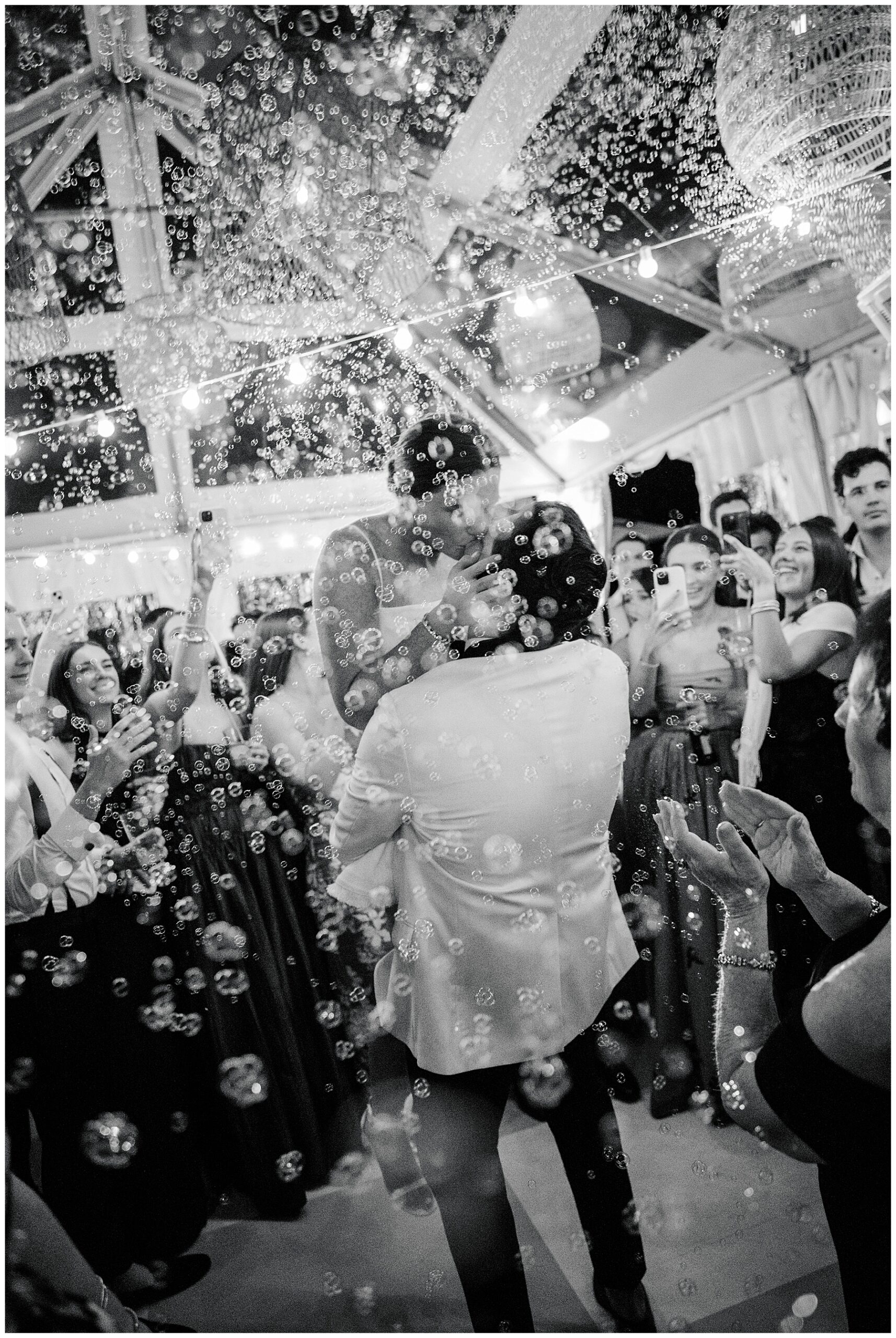 bride and groom pon dance floor with bubble machine 