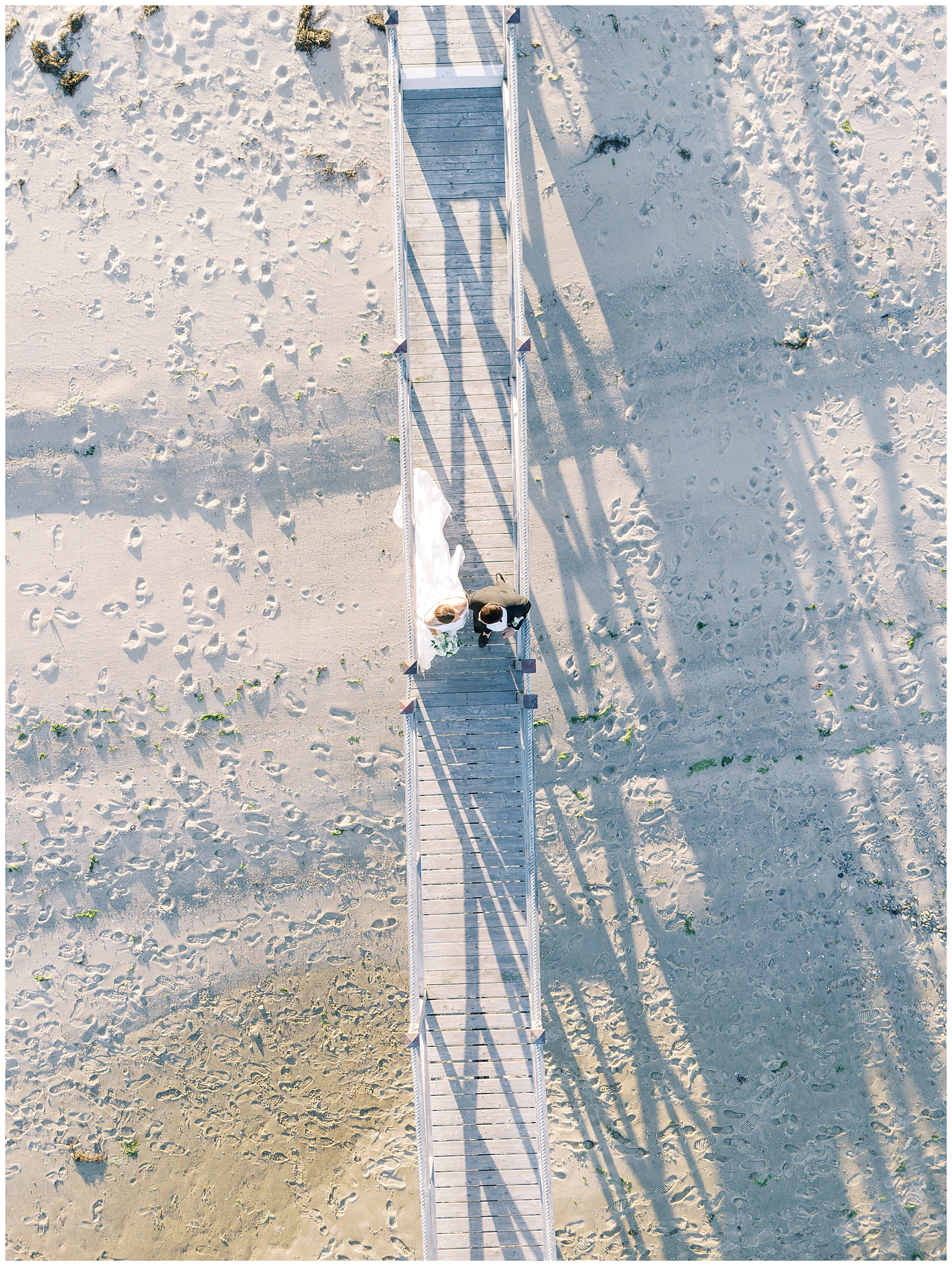 aerial photo of bride and groom on beach 