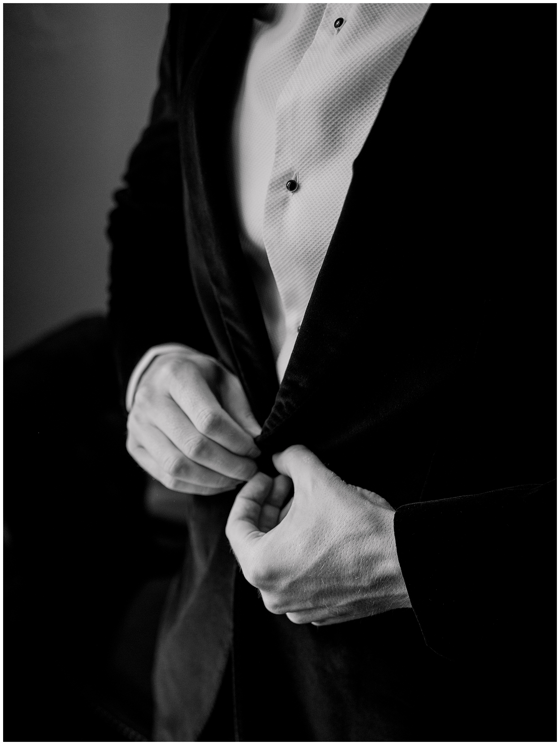 groom buttoning jacket