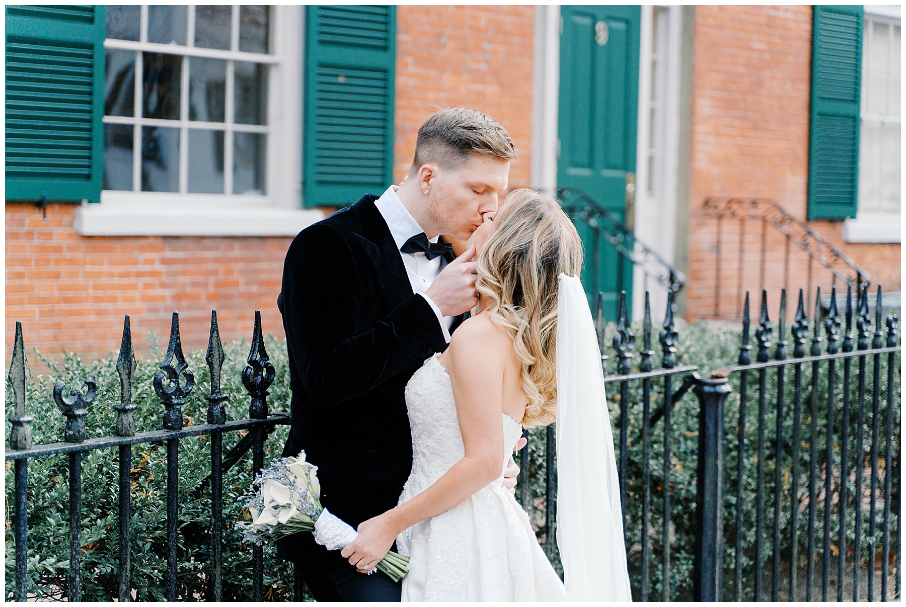 bride and groom kiss outside of historic Hamilton Hall