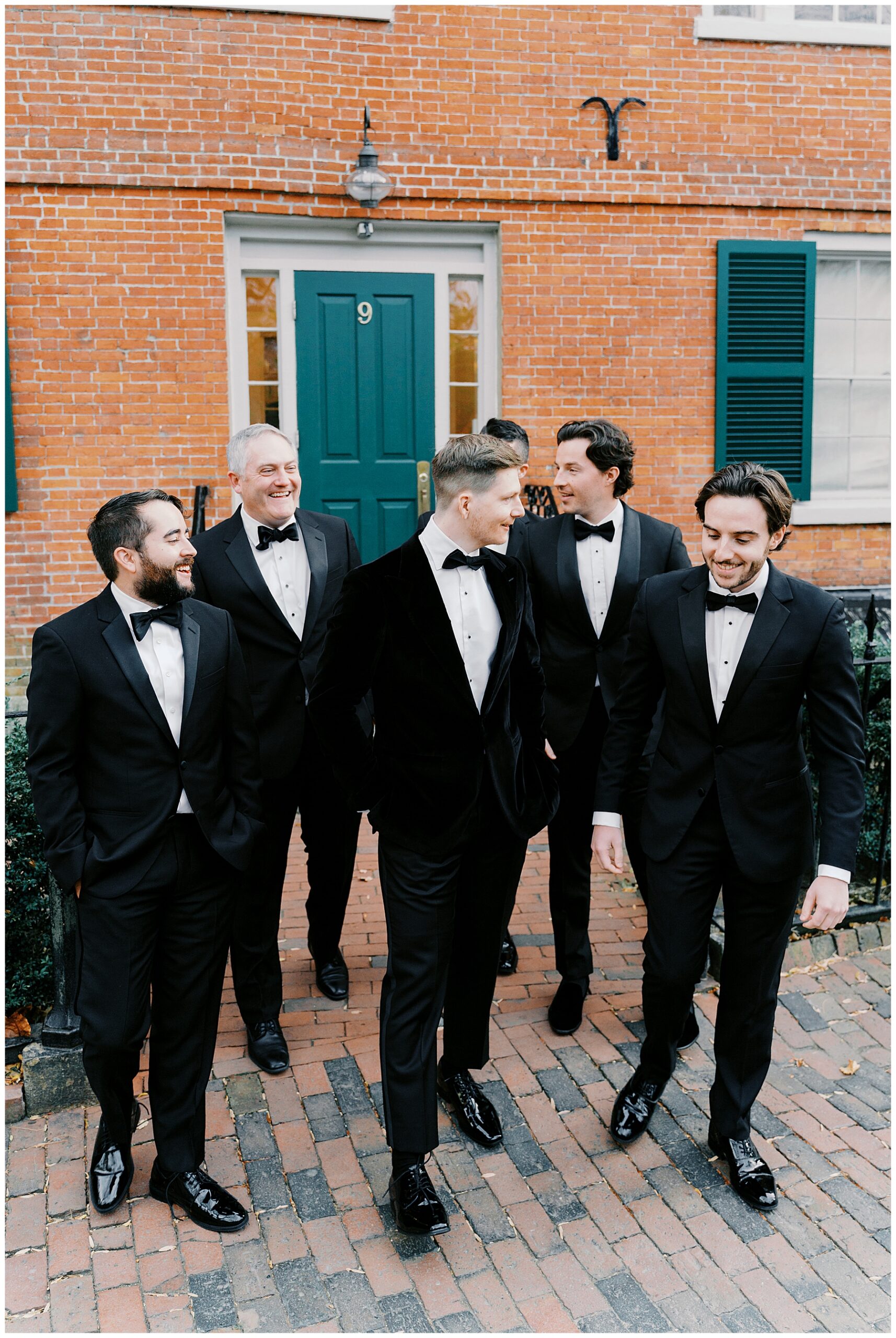 groomsmen walk with groom