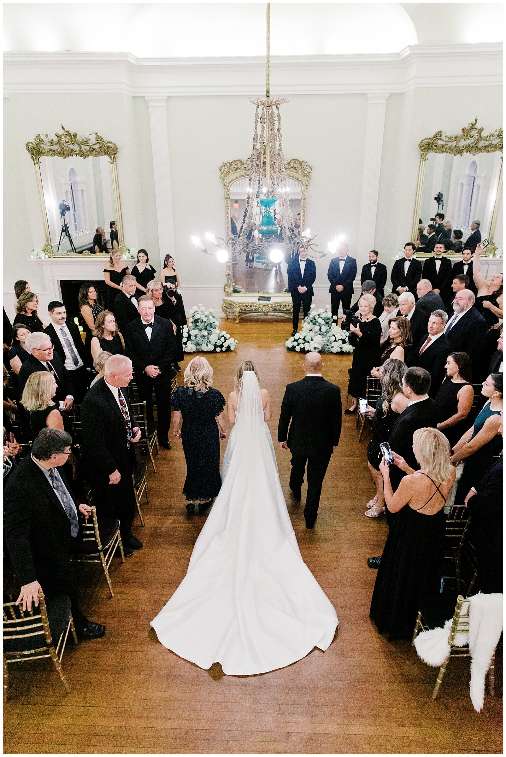 bride walking down aisle with parents