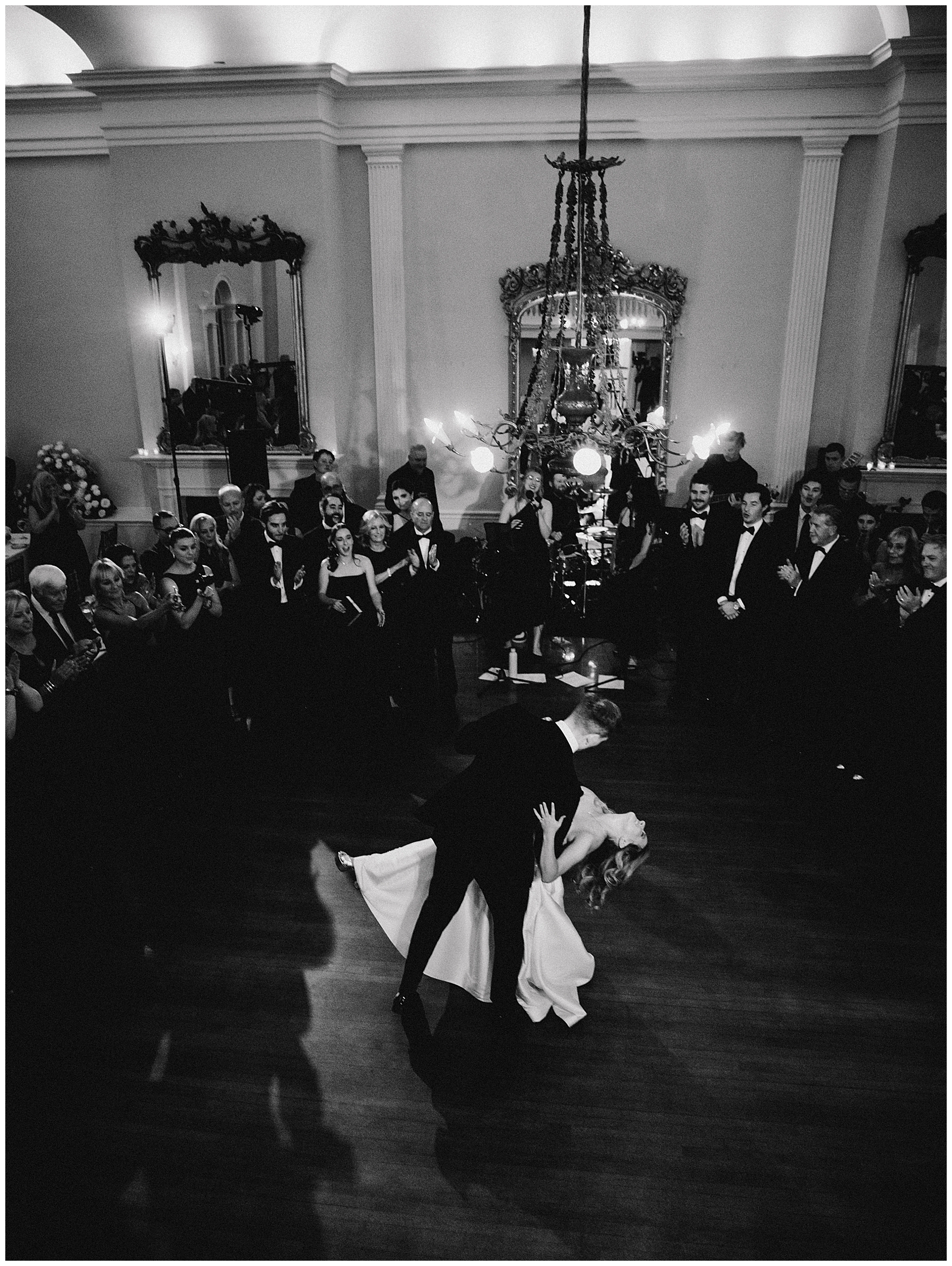 groom dips bride on dance floor