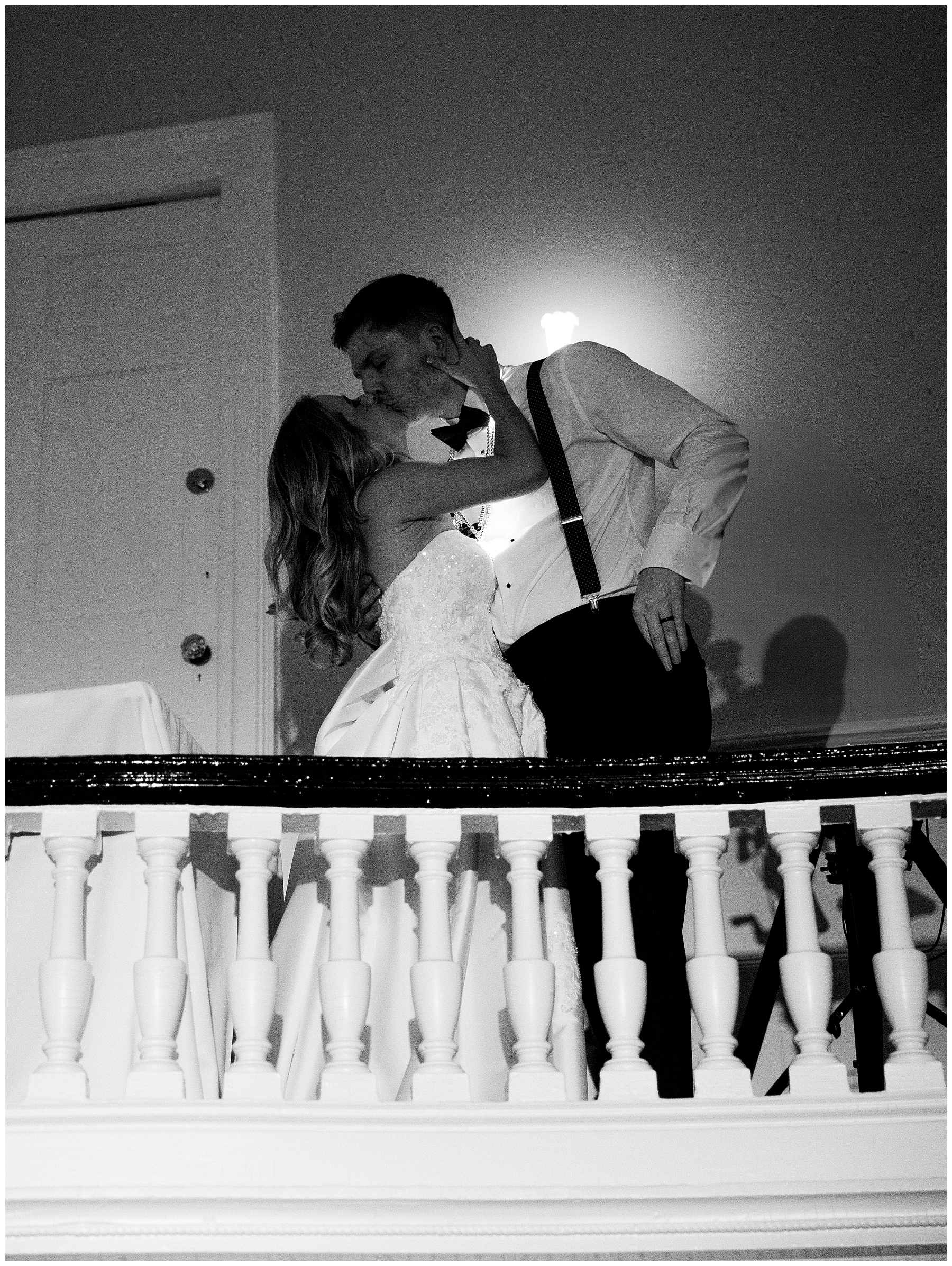 newlyweds kiss on balcony