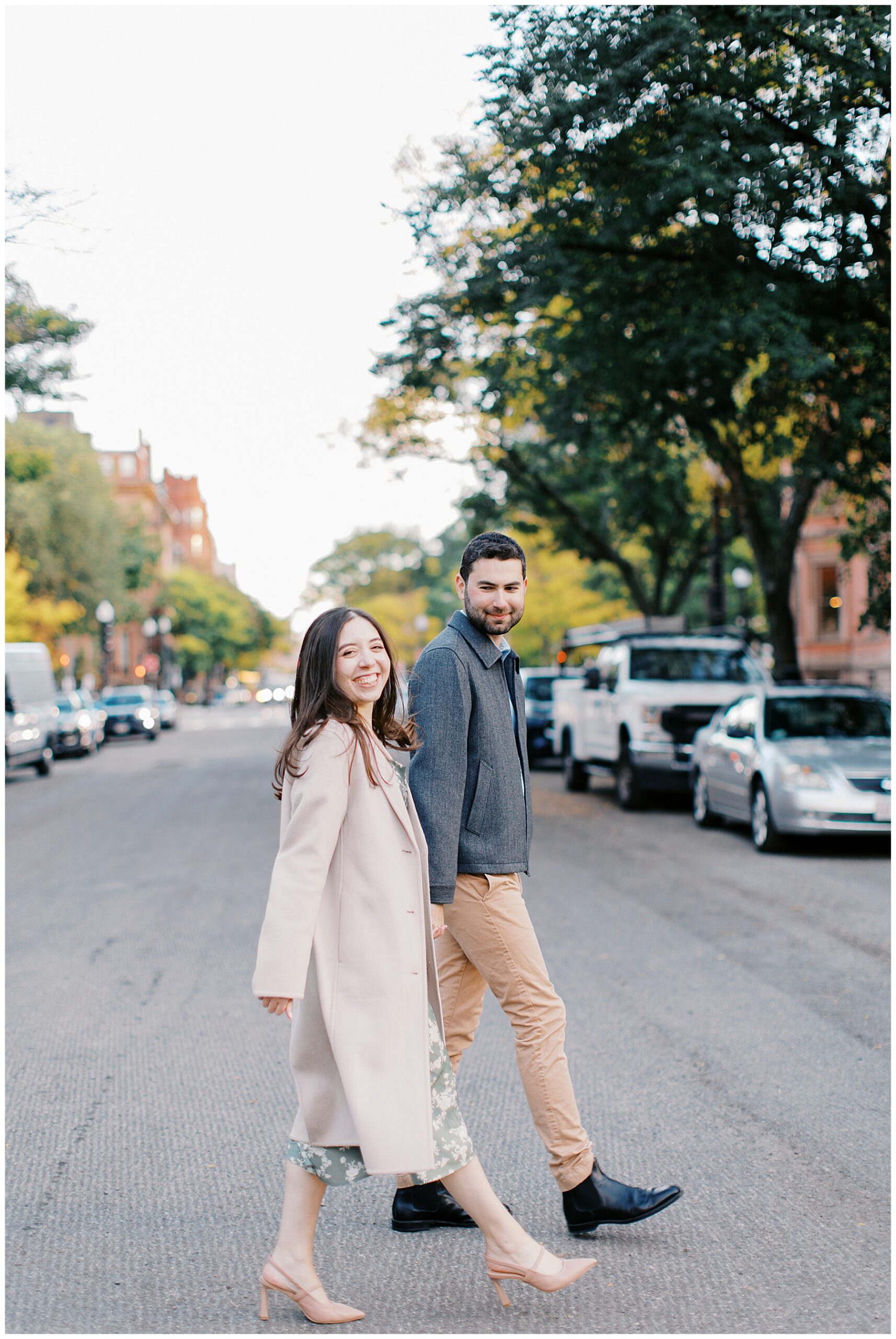 couple walk across street in Boston 