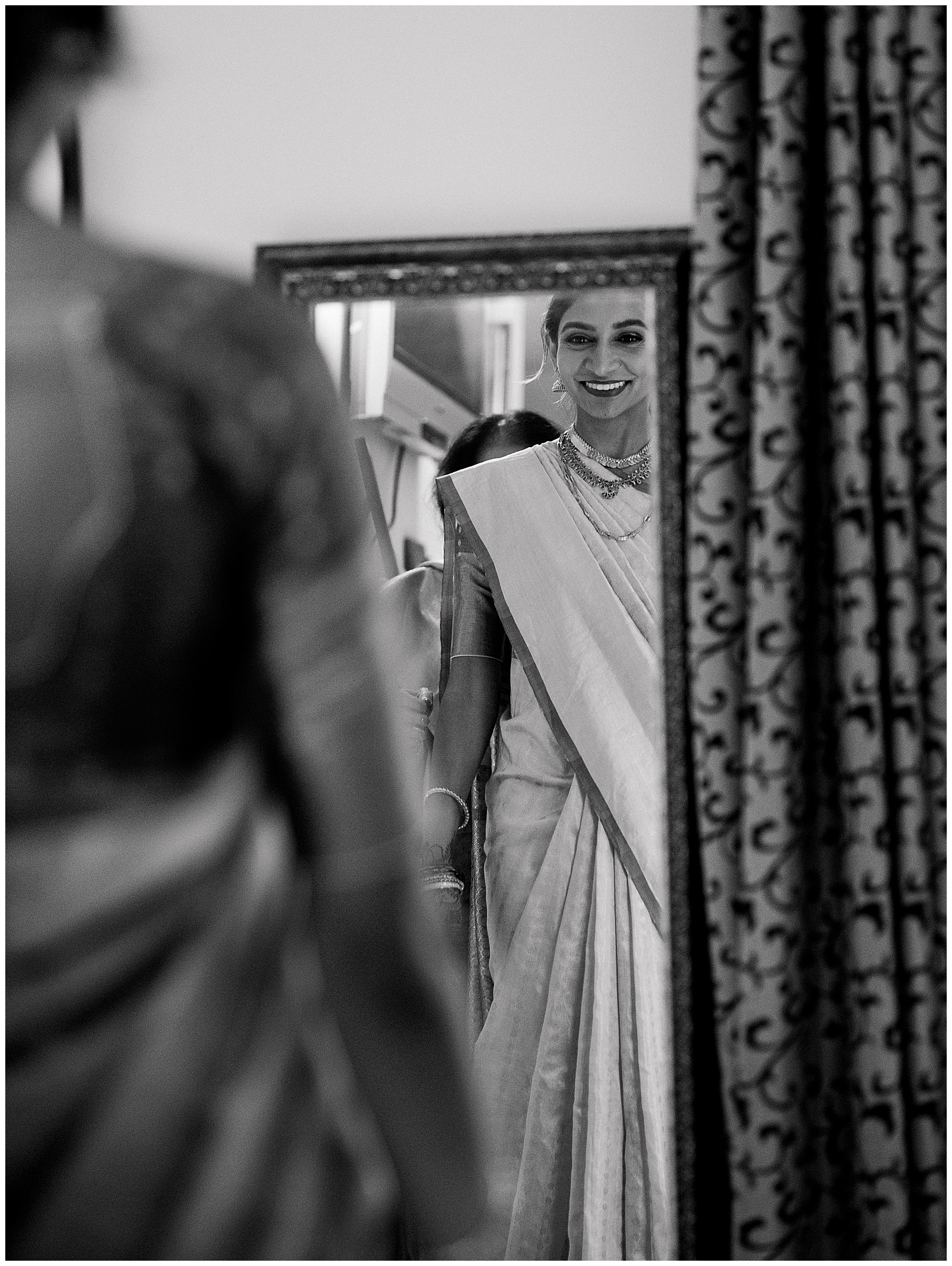 bride looks at herself in mirror