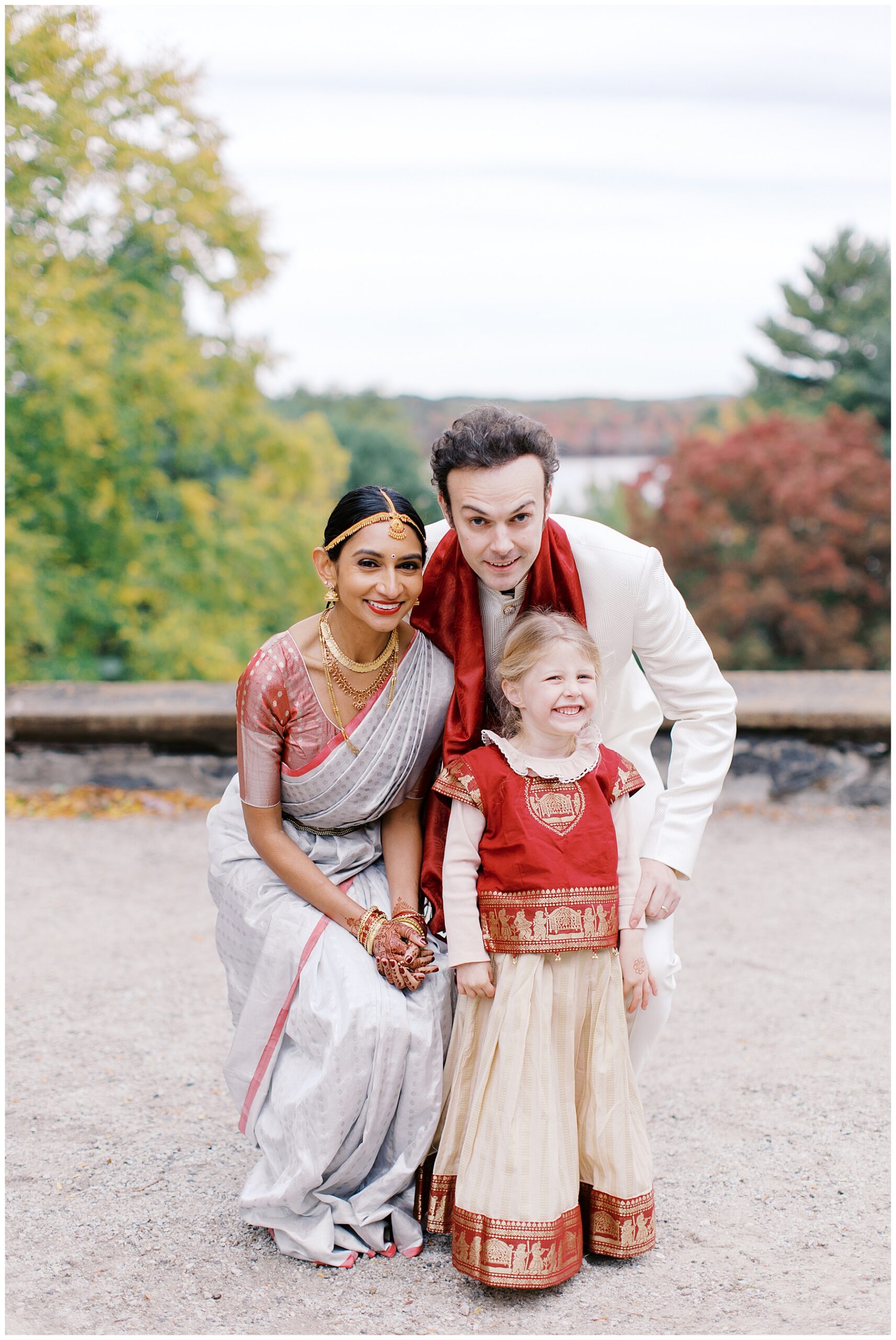bride and groom with little girl in wedding