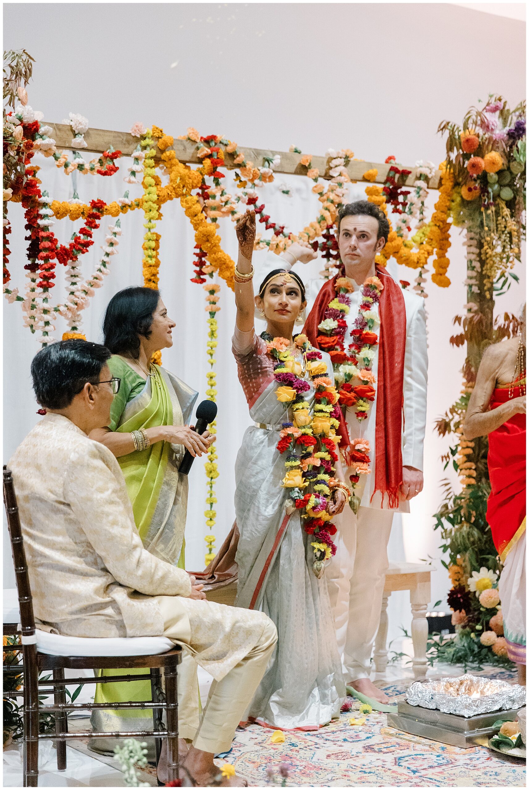 Bride and groom at wedding ceremony with colorful florals
