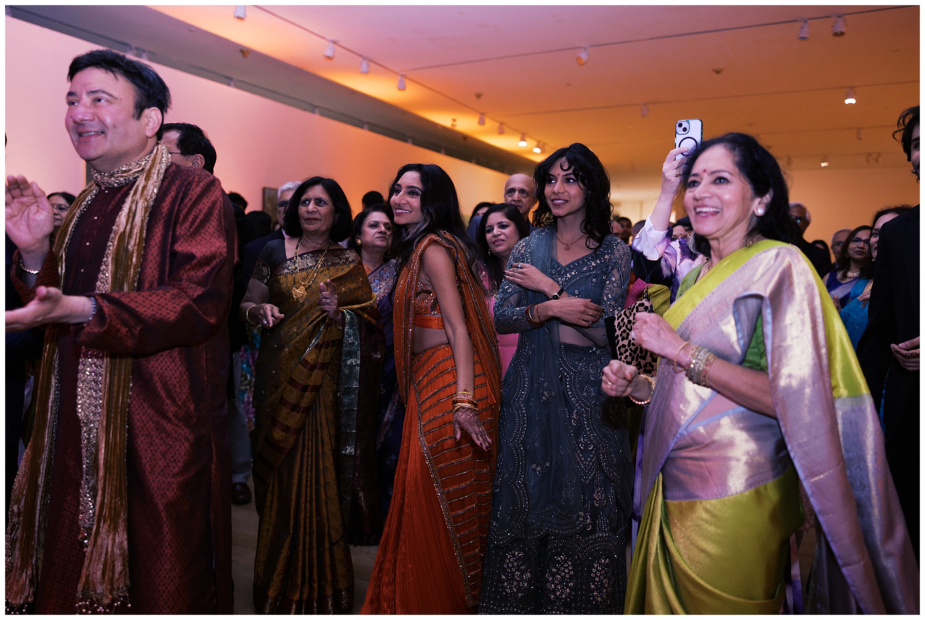 wedding guests in traditional Indian outfits on dance floor