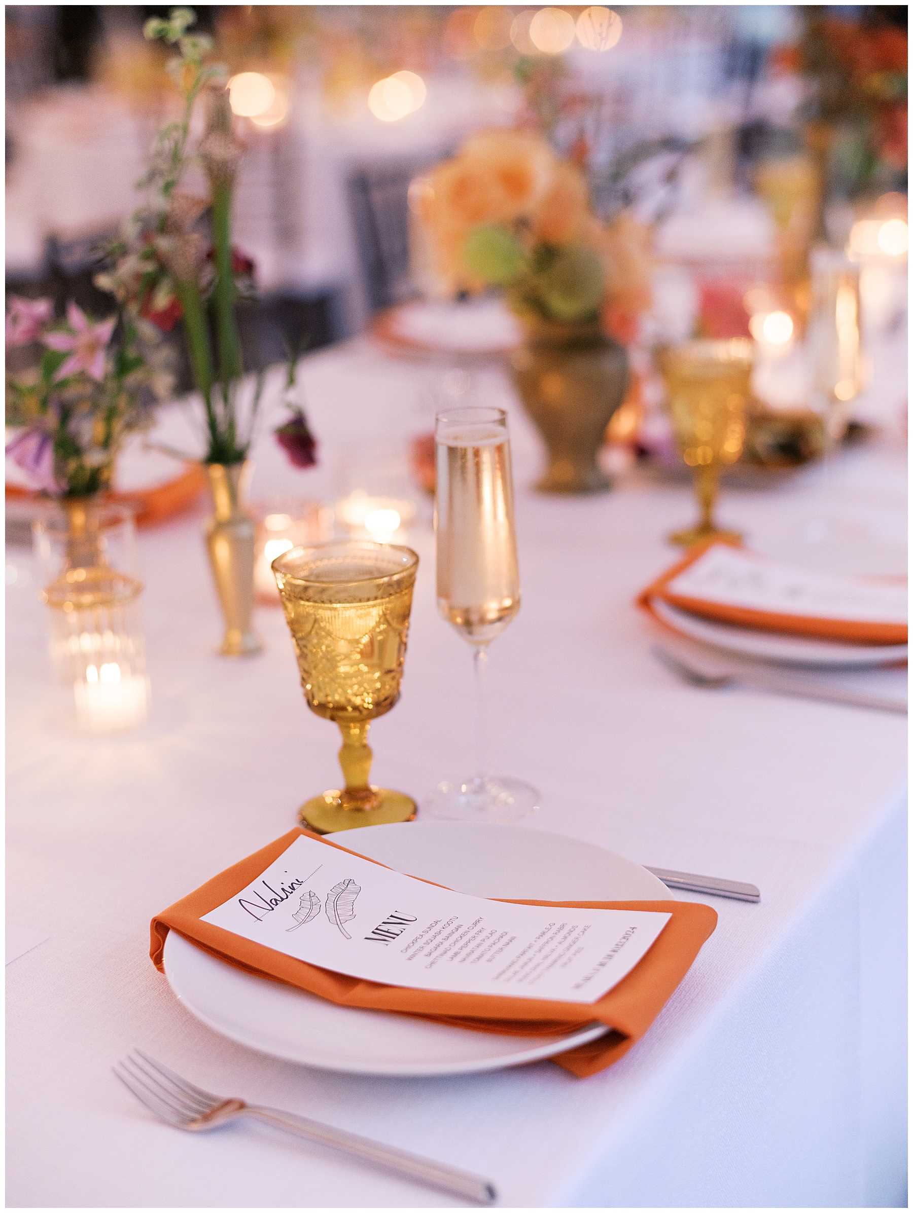 orange napkins decorate place setting with yellow glassware
