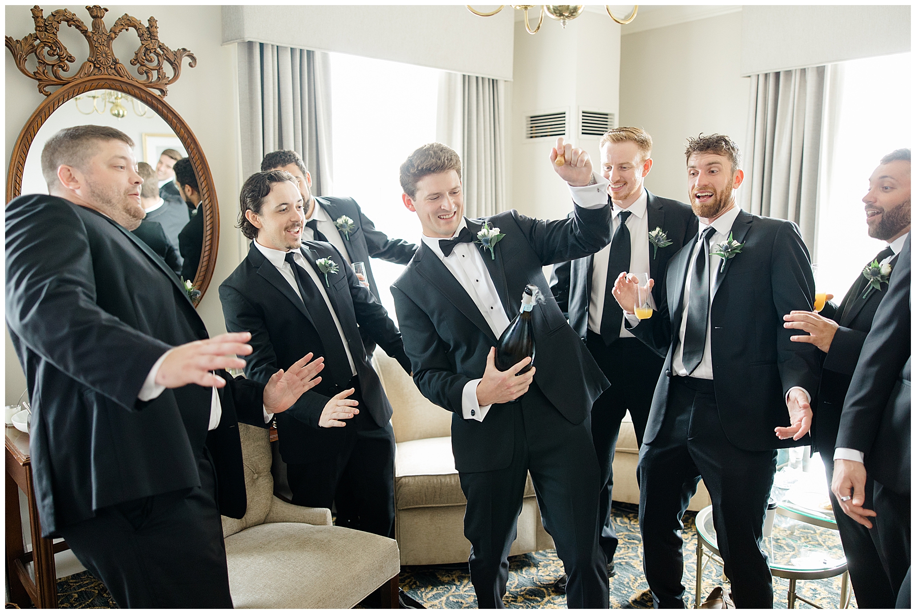 groom opening champagne with groomsmen