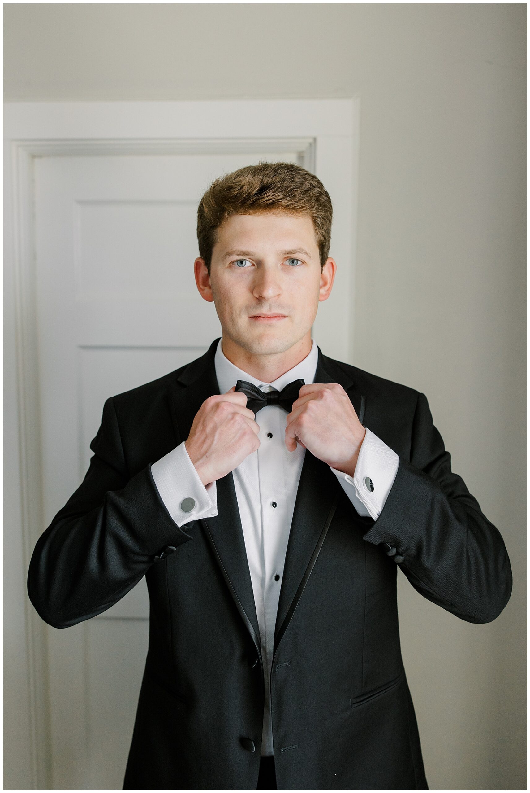 groom straightening bowtie