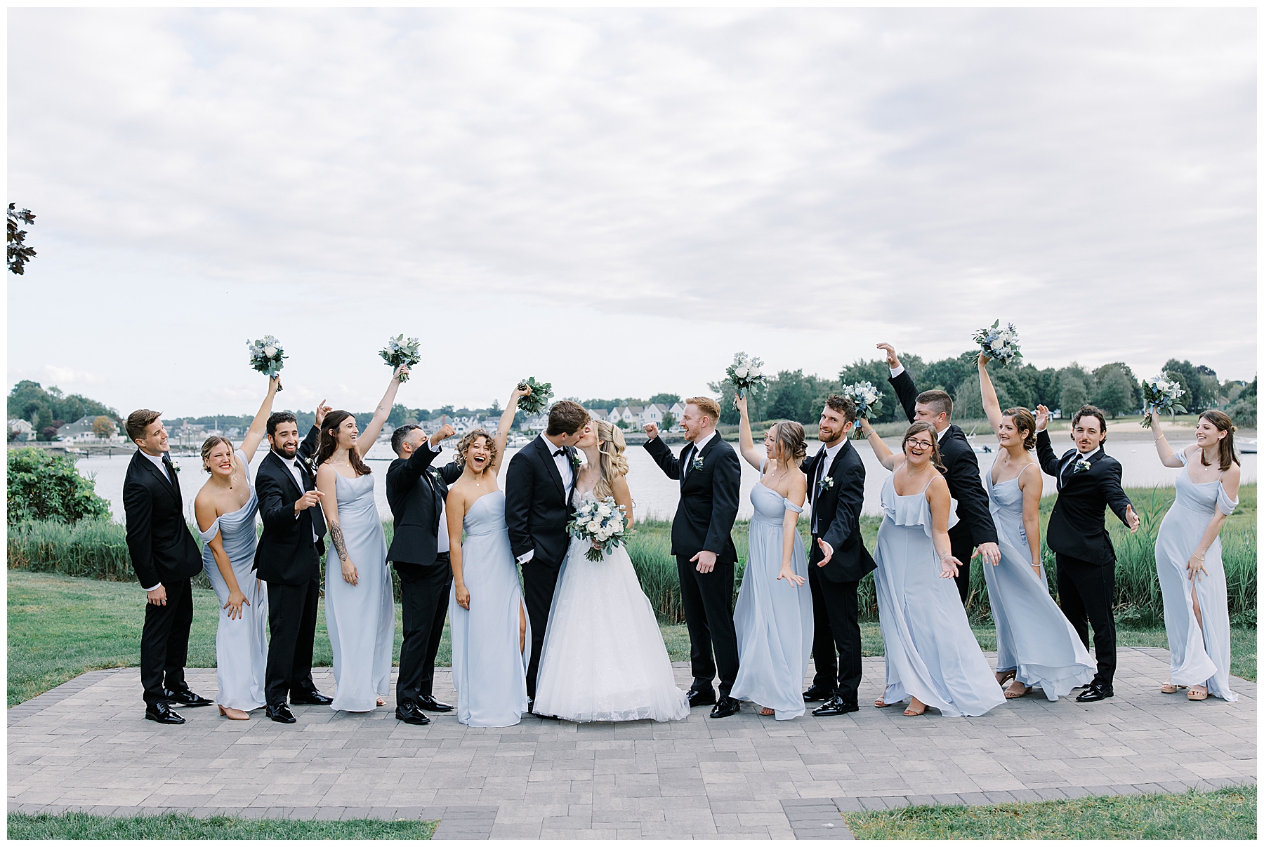 wedding party celebrates around bride and groom 