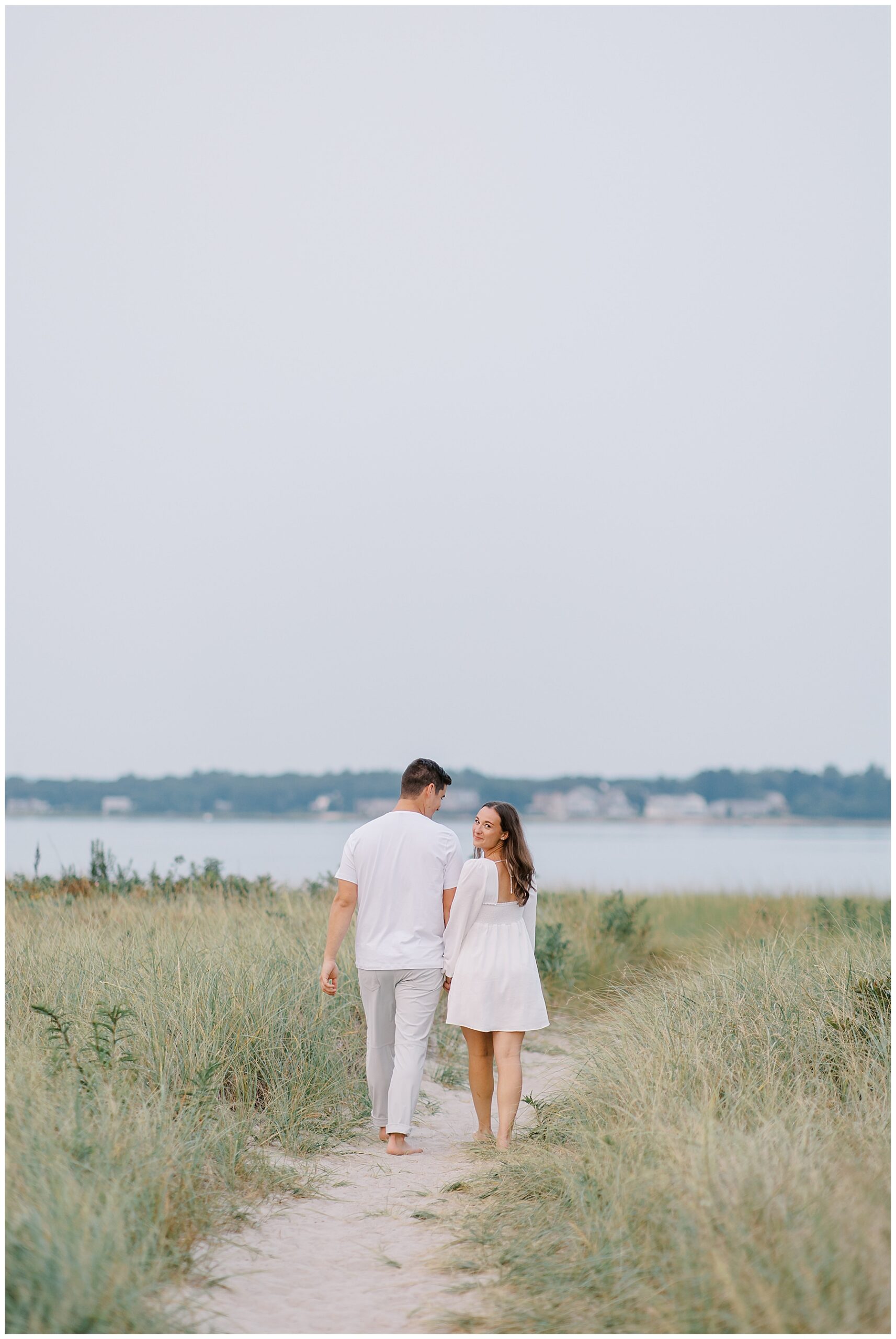 couple walk towards the beach in Cape Cod