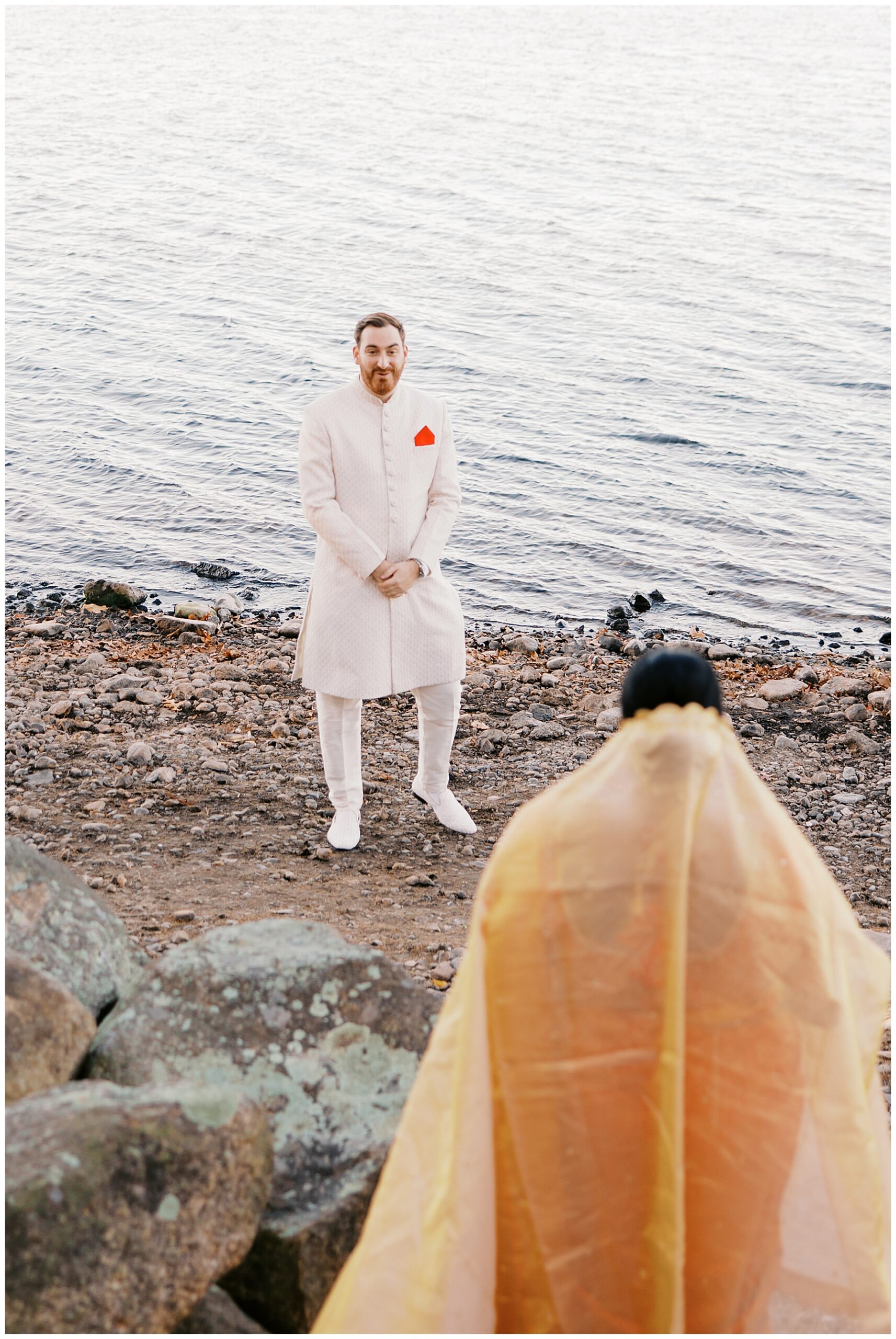 bride and groom first look by the water