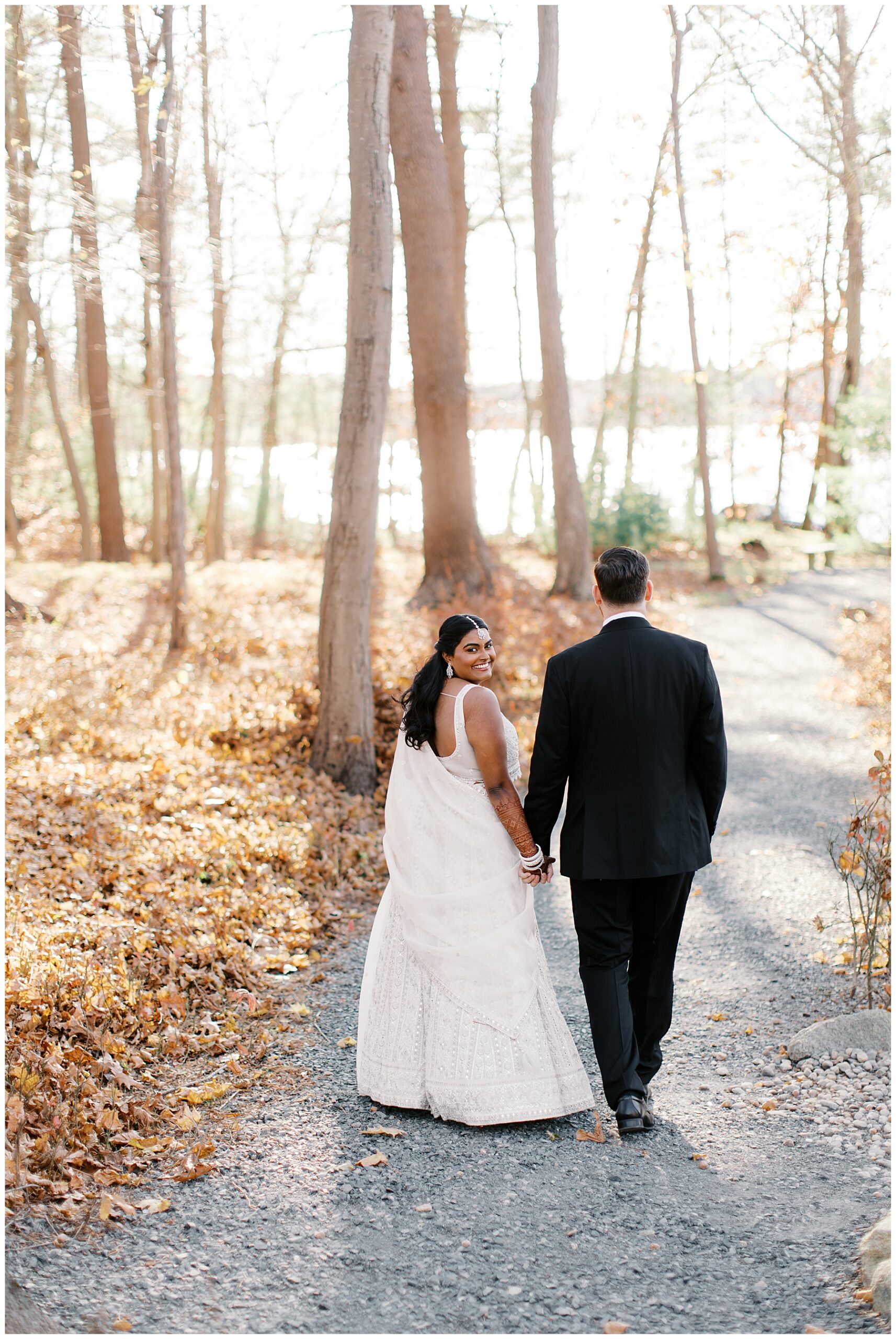 newlyweds walk together holding hands