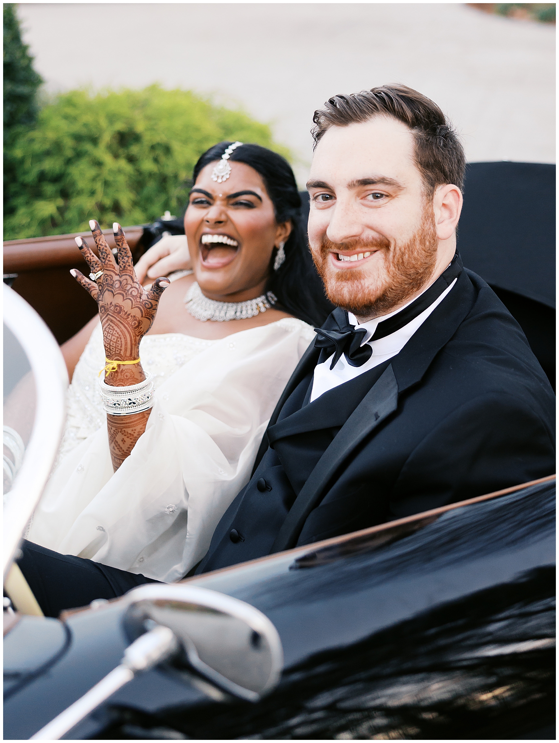 bride shows off her wedding ring while couple drives off in car