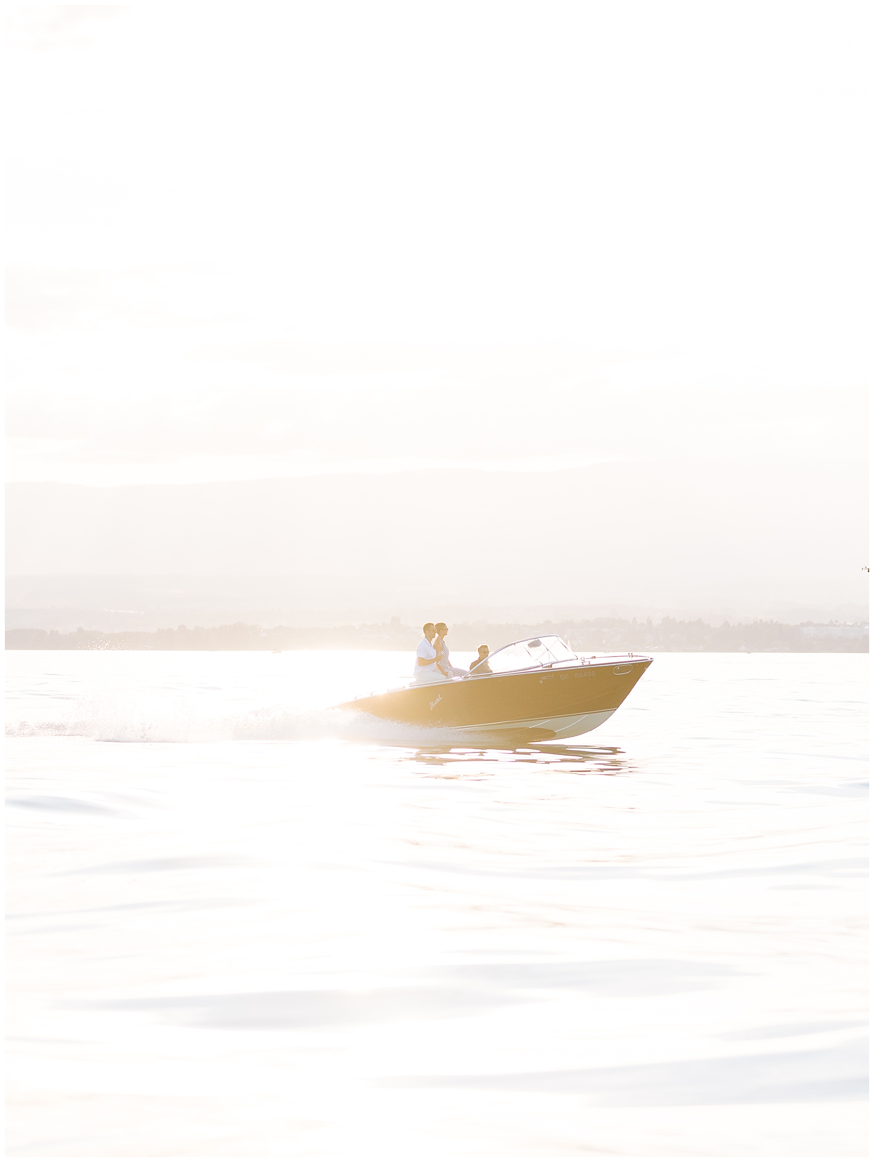 Couple enjoy a sunset boat ride on Lake Geneva in Switzerland