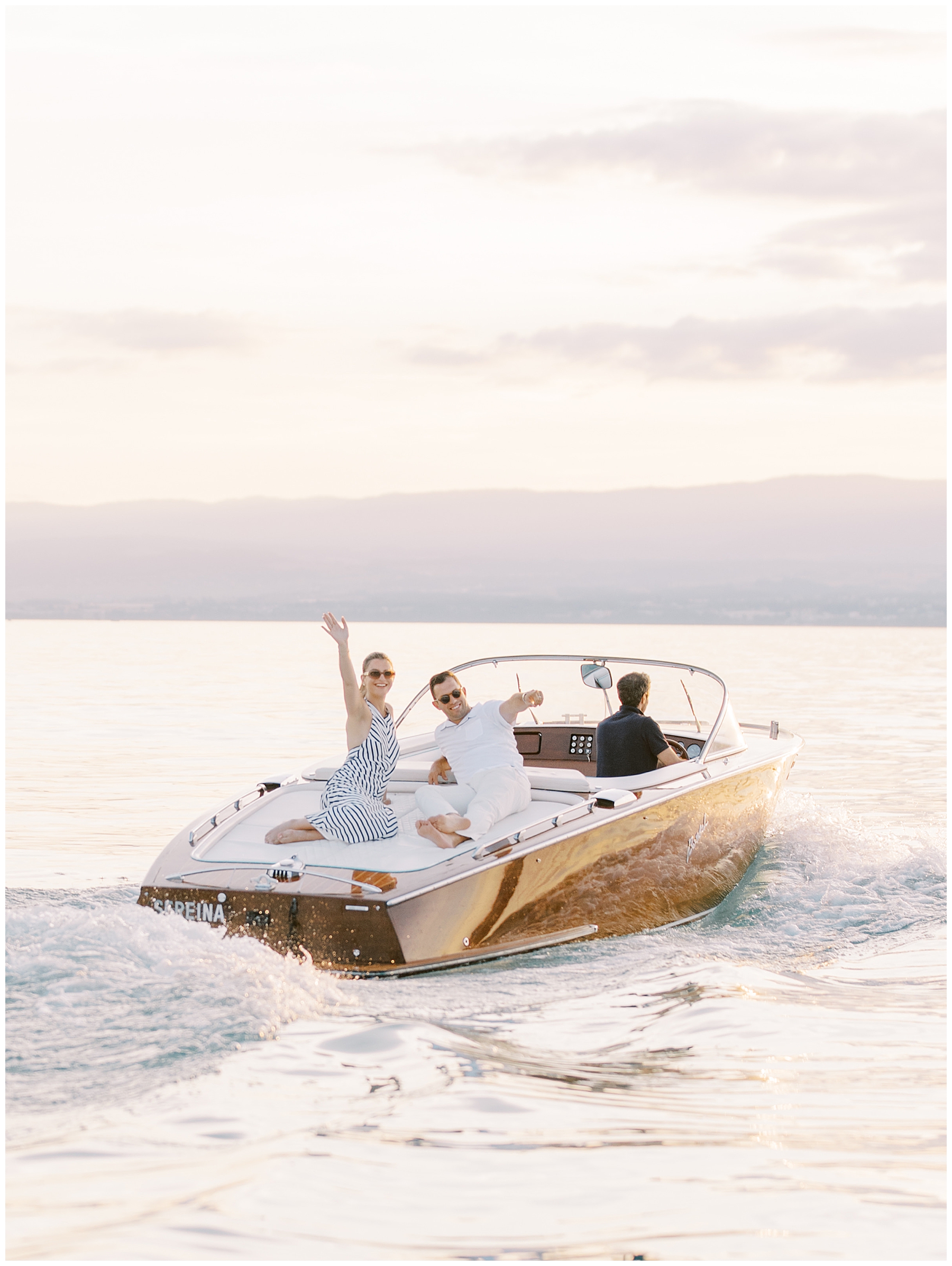 couple wave as they ride on boat