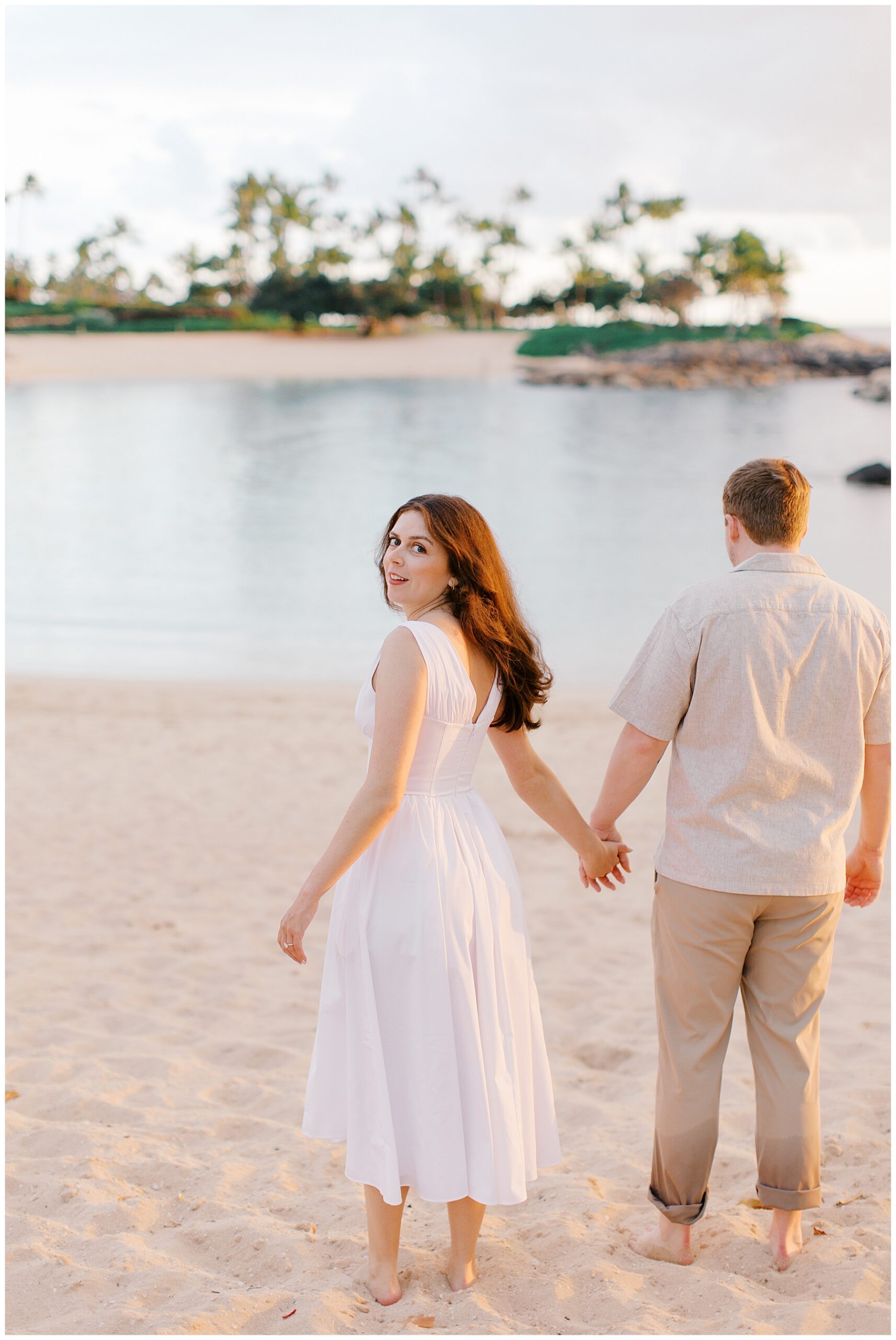 Ko Olina engagement photos of couple walking togehter on the beach