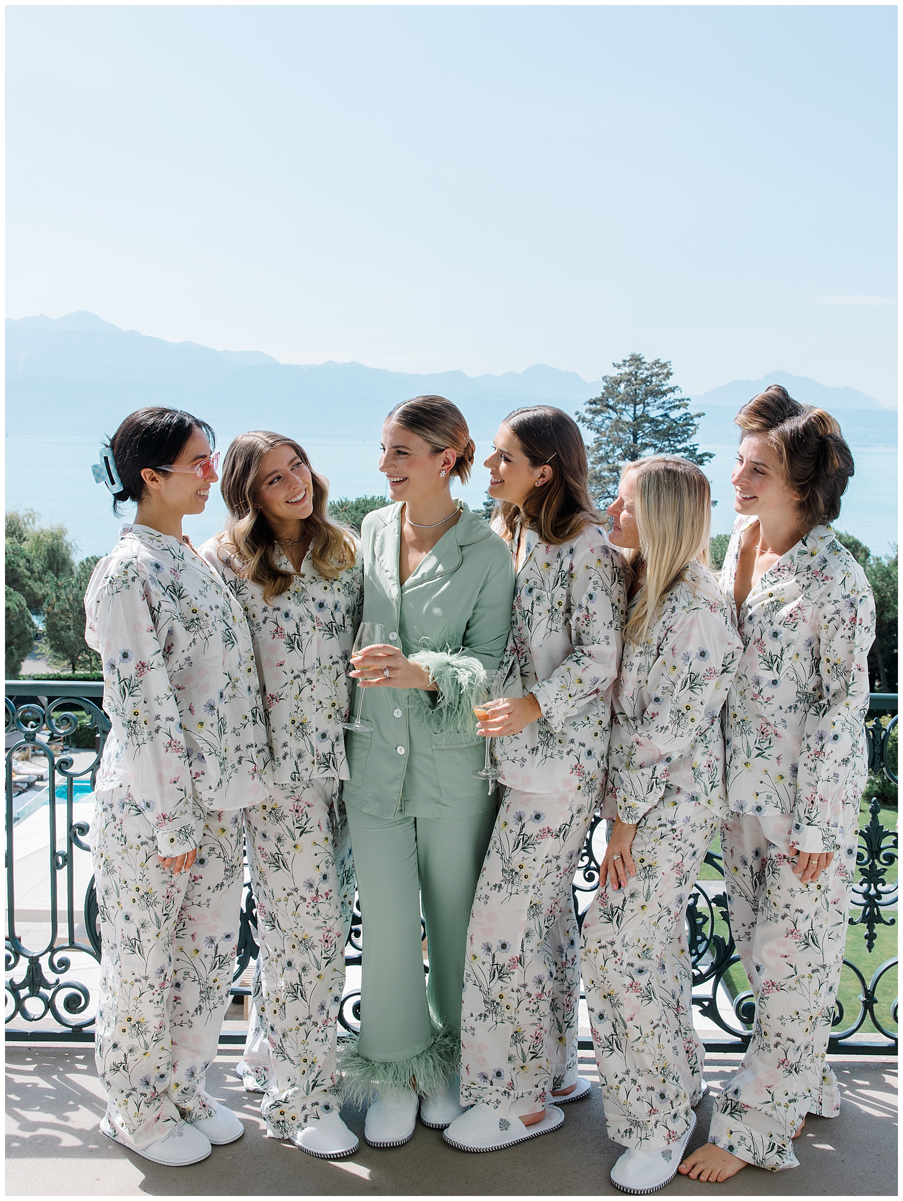 bride and bridesmaids in matching pjs on balcony of hotel at Beau-Rivage Palace