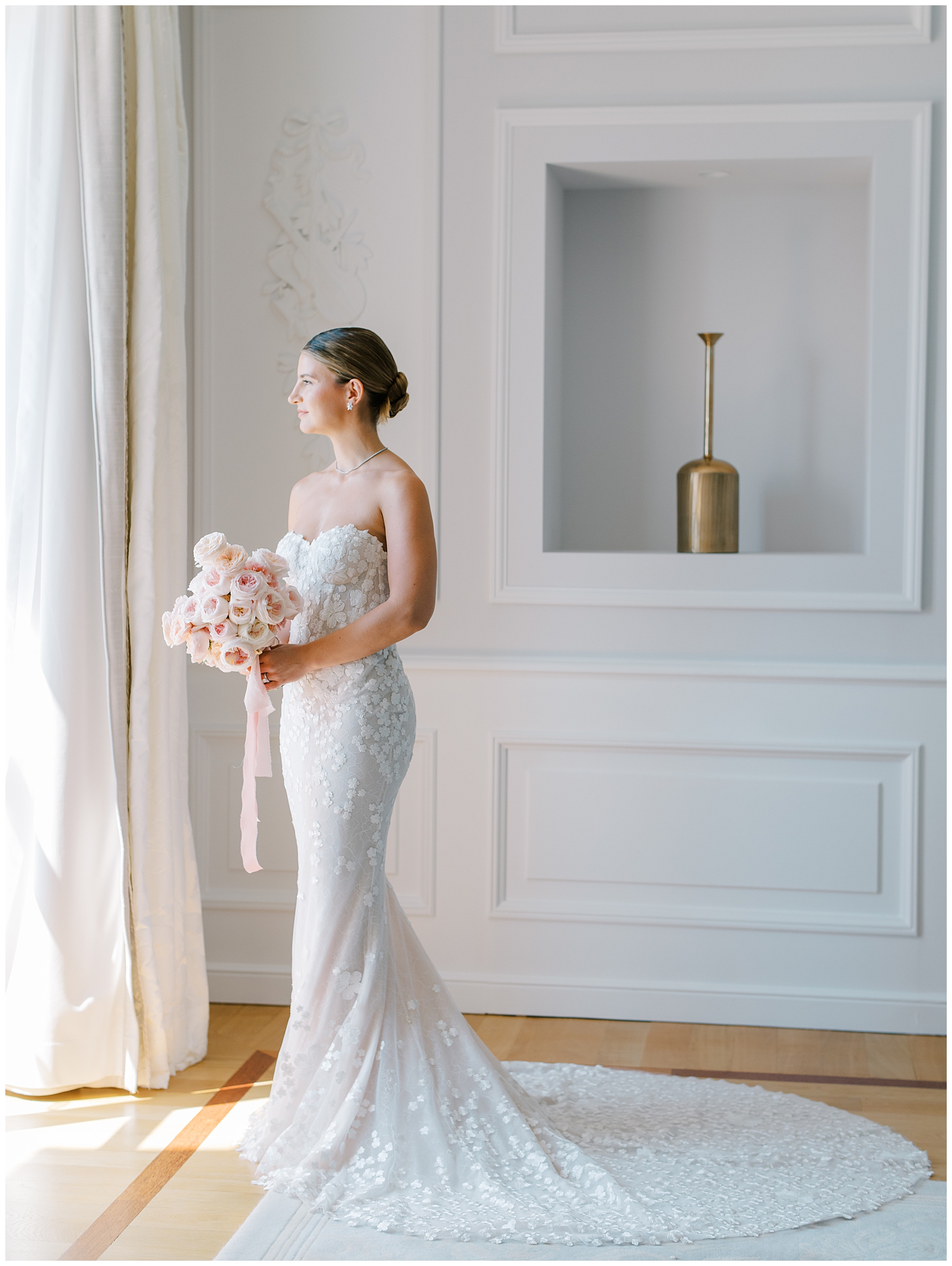 bride in wedding dress looking out window