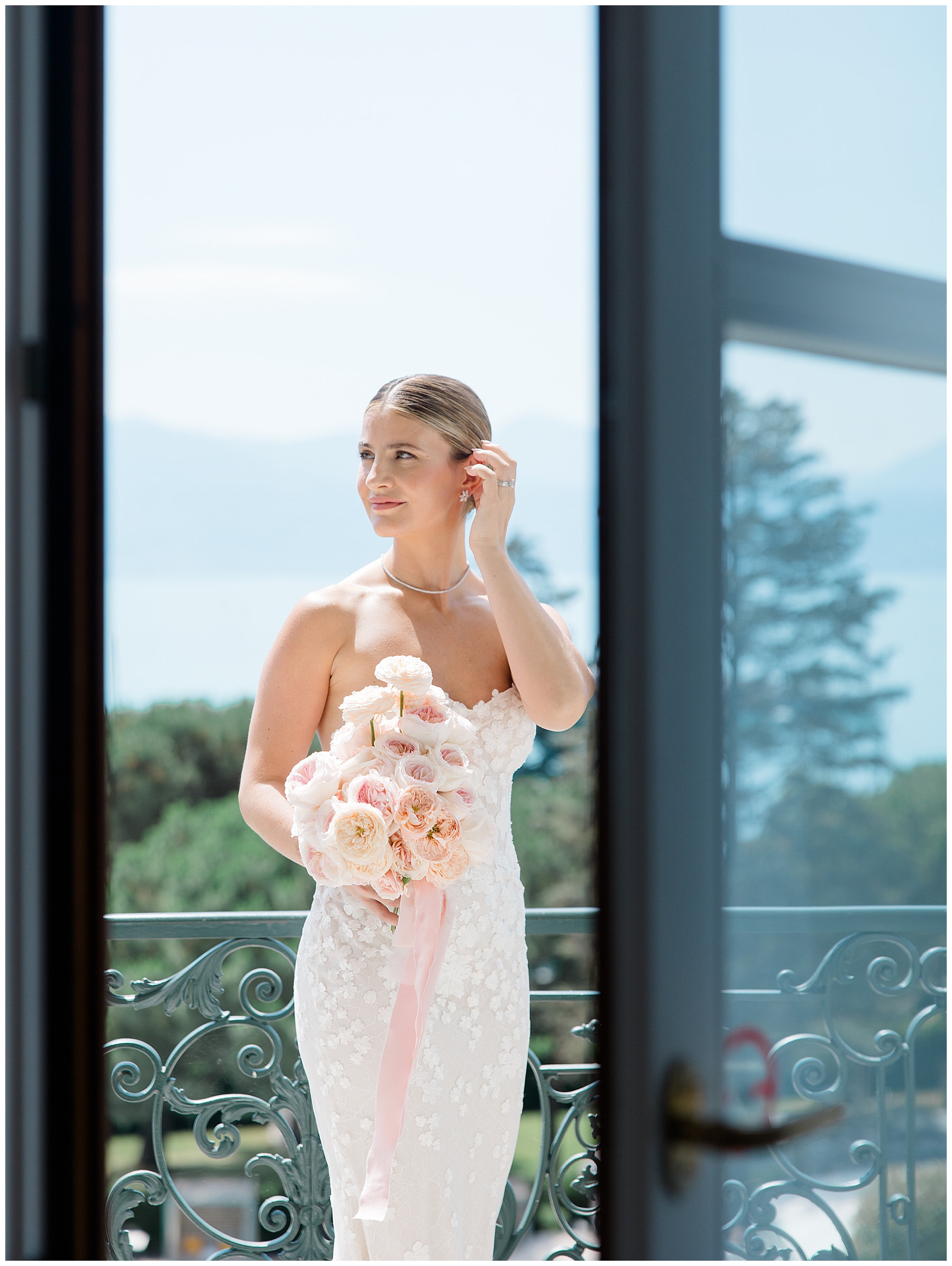 bride stands on balcony of Beau-Rivage Palace in Switzerland