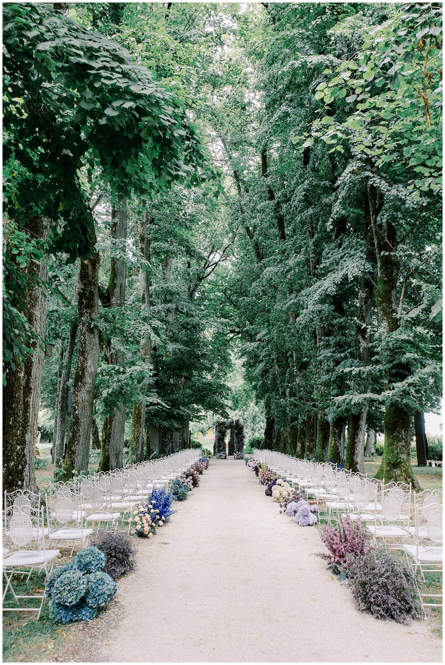 lush florals line aisle in outdoor wedding ceremony in Switzerland